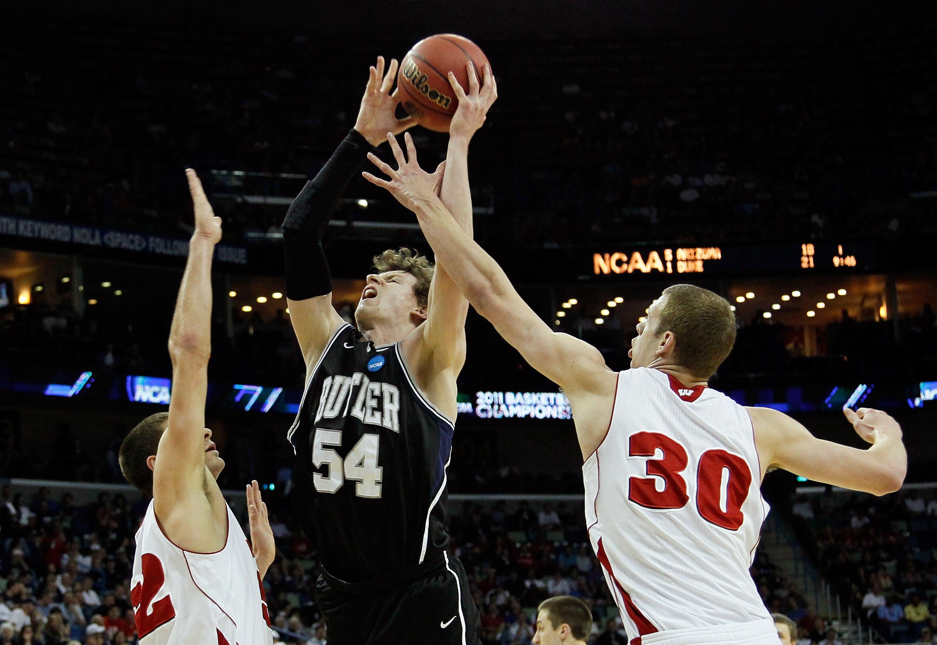 NEW ORLEANS, LA - MARCH 24:  Matt Howard #54 of the Butler Bulldogs shoots between Keaton Nankivil #52 and Jon Leuer #30 of the Wisconsin Badgers during the Southeast regional of the 2011 NCAA men's basketball tournament at New Orleans Arena on March 24,