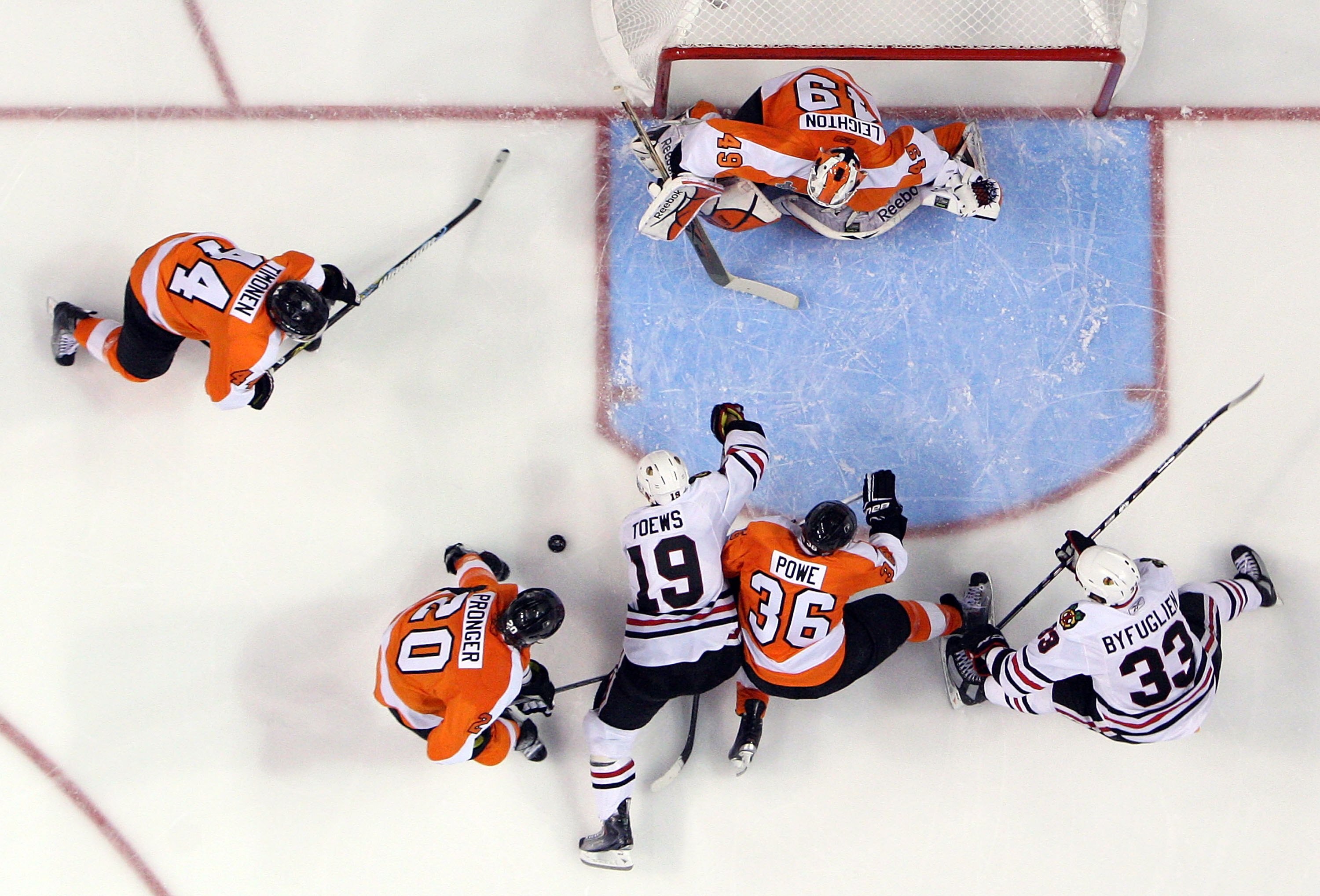 PHILADELPHIA - JUNE 09:  Jonathan Toews #19 and Dustin Byfuglien #33 of the Chicago Blackhawks are stopped by Michael Leighton #49, Darroll Powe #36, Chris Pronger #20, and Kimmo Timonen #44 of the Philadelphia Flyers in Game Six of the 2010 NHL Stanley C