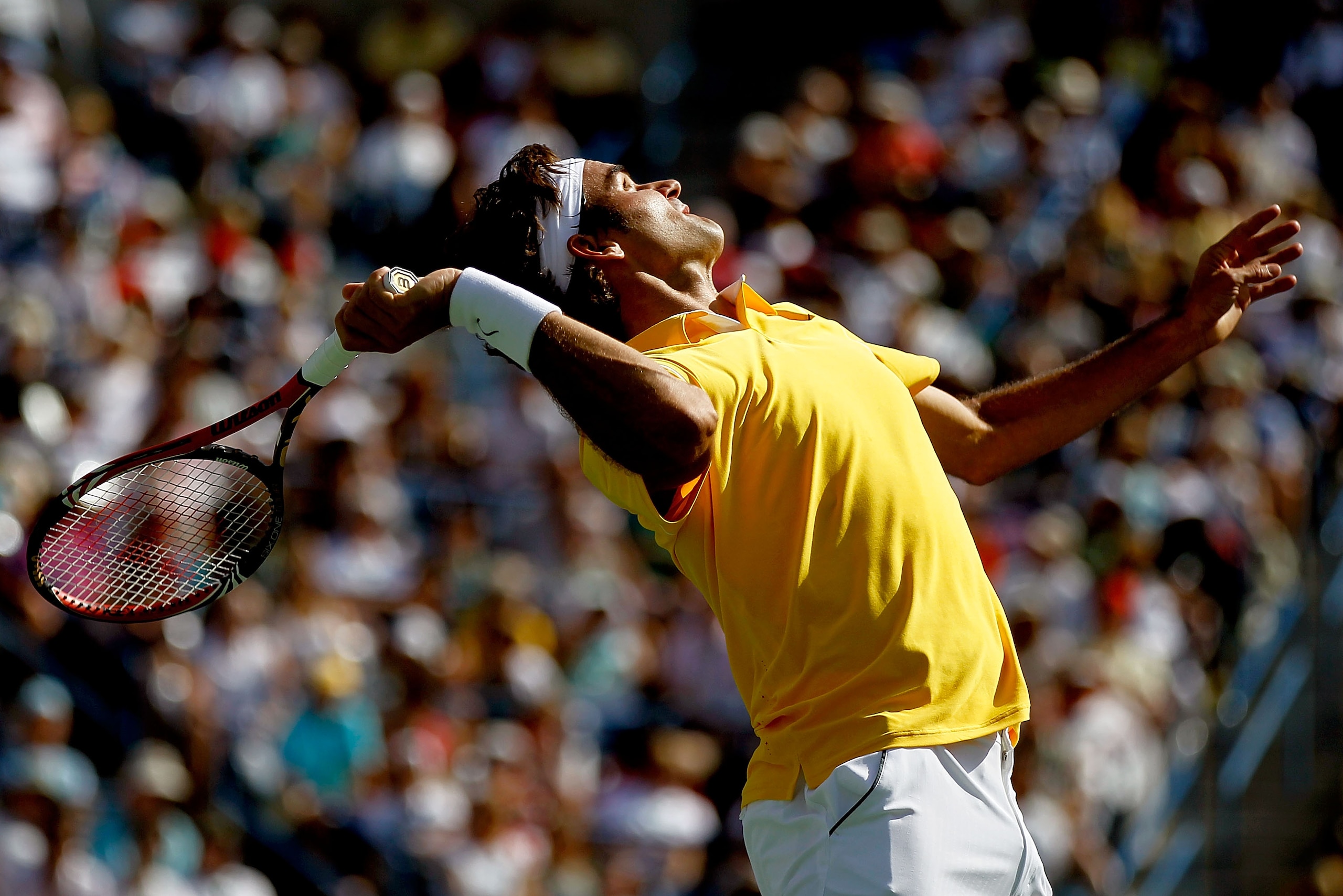 INDIAN WELLS, CA - MARCH 19: Roger Federer of Switzerland serves to Novak Djokovic of Serbia during the semifinals of the BNP Paribas Open at the Indian Wells Tennis Garden on March 19, 2011 in Indian Wells, California.  (Photo by Matthew Stockman/Getty I