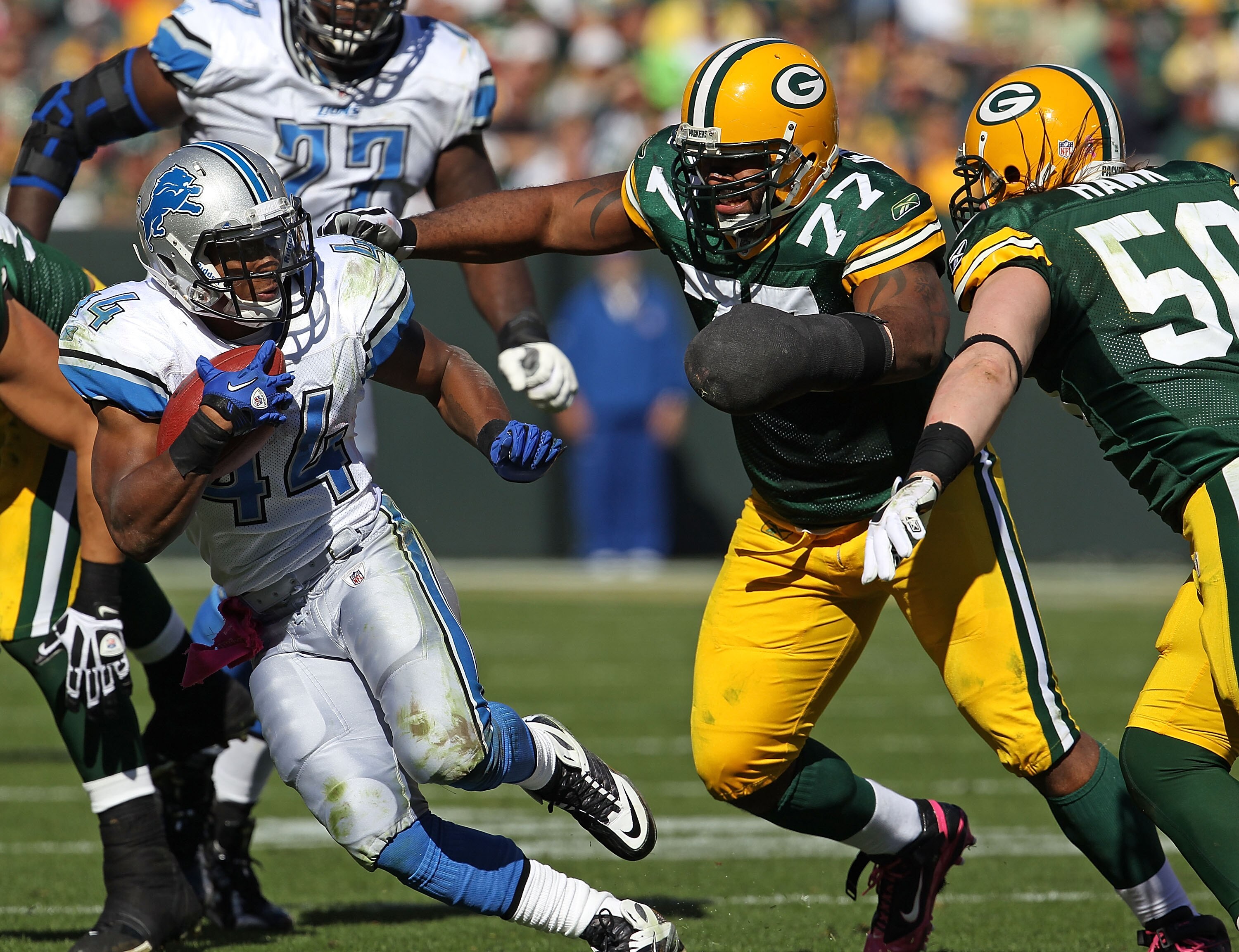 GREEN BAY, WI - OCTOBER 03: Jahvid Best #44 of the Detroit Lions moves to avoid Cullen Jenkins #77 and A.J. Hawk #50 of the Green Bay Packers at Lambeau Field on October 3, 2010 in Green Bay, Wisconsin. The Packers defeated the Lions 28-26. (Photo by Jona