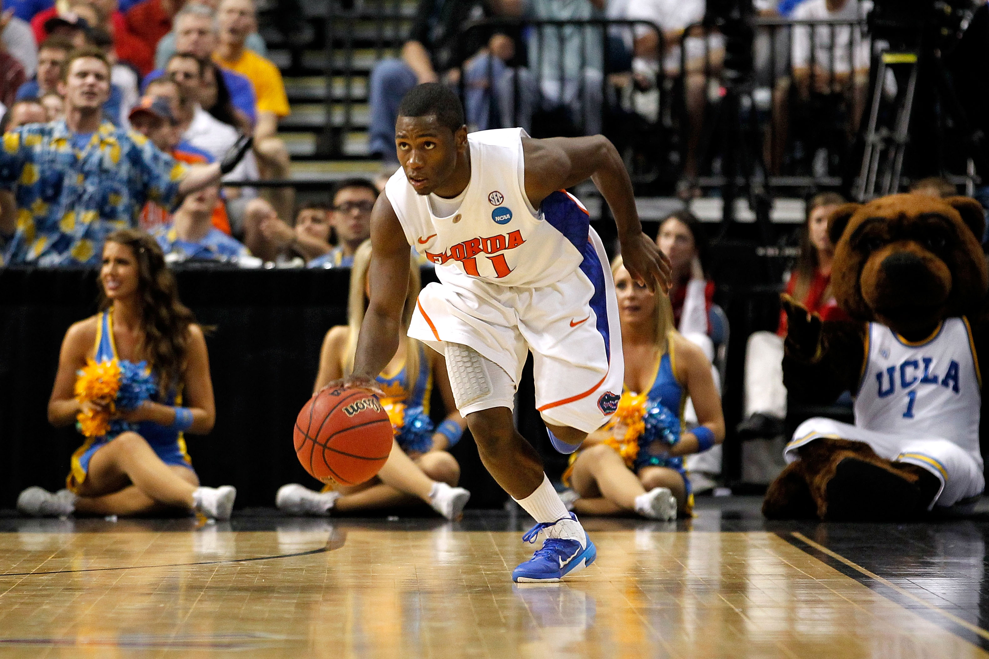 TAMPA, FL - MARCH 19:  Erving Walker #11 of the Florida Gators pushes the ball up court against the UCLA Bruins during the third round of the 2011 NCAA men's basketball tournament at St. Pete Times Forum on March 19, 2011 in Tampa, Florida. Florida won 73