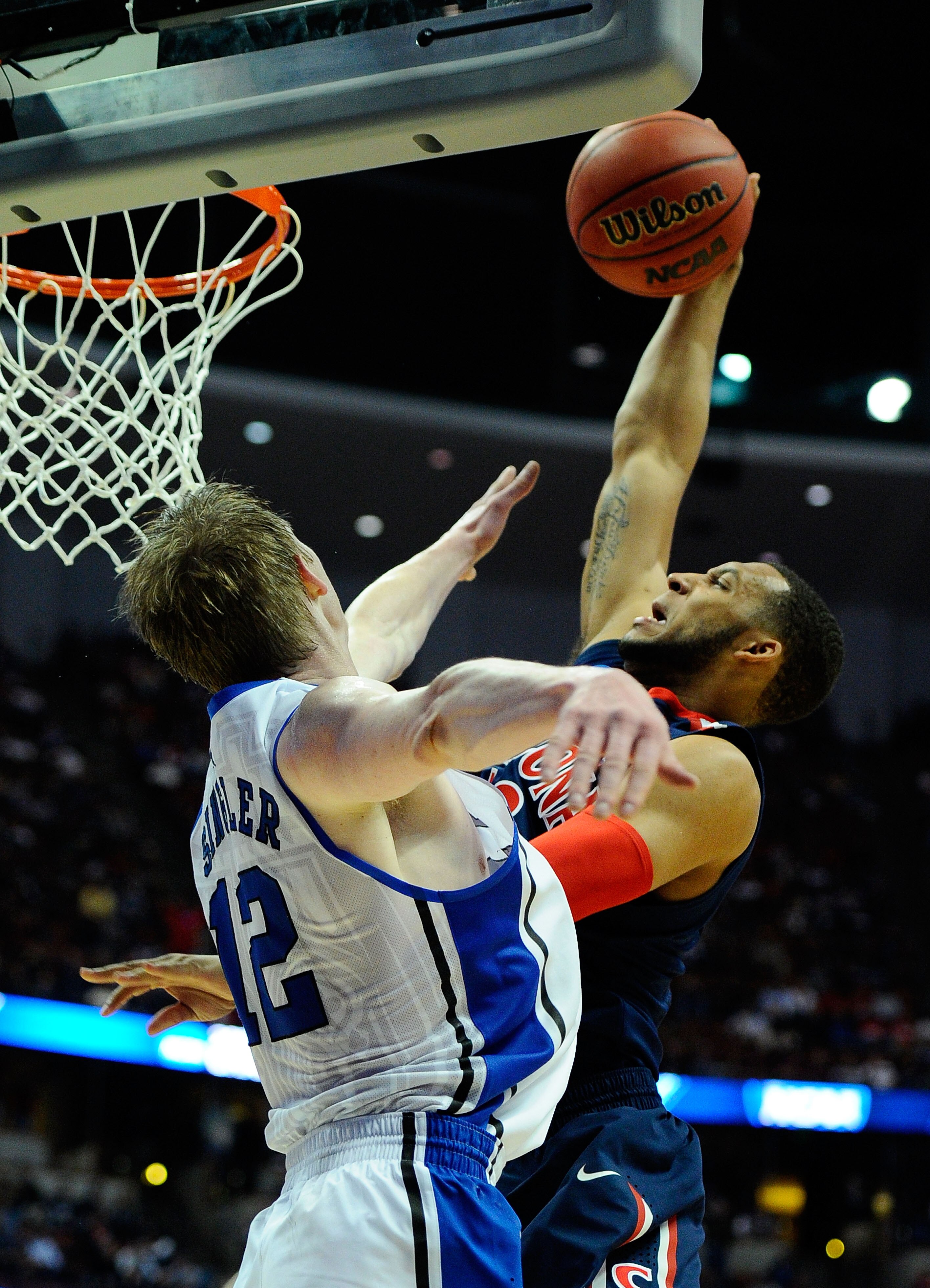 ANAHEIM, CA - MARCH 24:  Derrick Williams #23 of the Arizona Wildcats dunks the over Kyle Singler #12 of the Duke Blue Devils during the west regional semifinal of the 2011 NCAA men's basketball tournament at the Honda Center on March 24, 2011 in Anaheim,