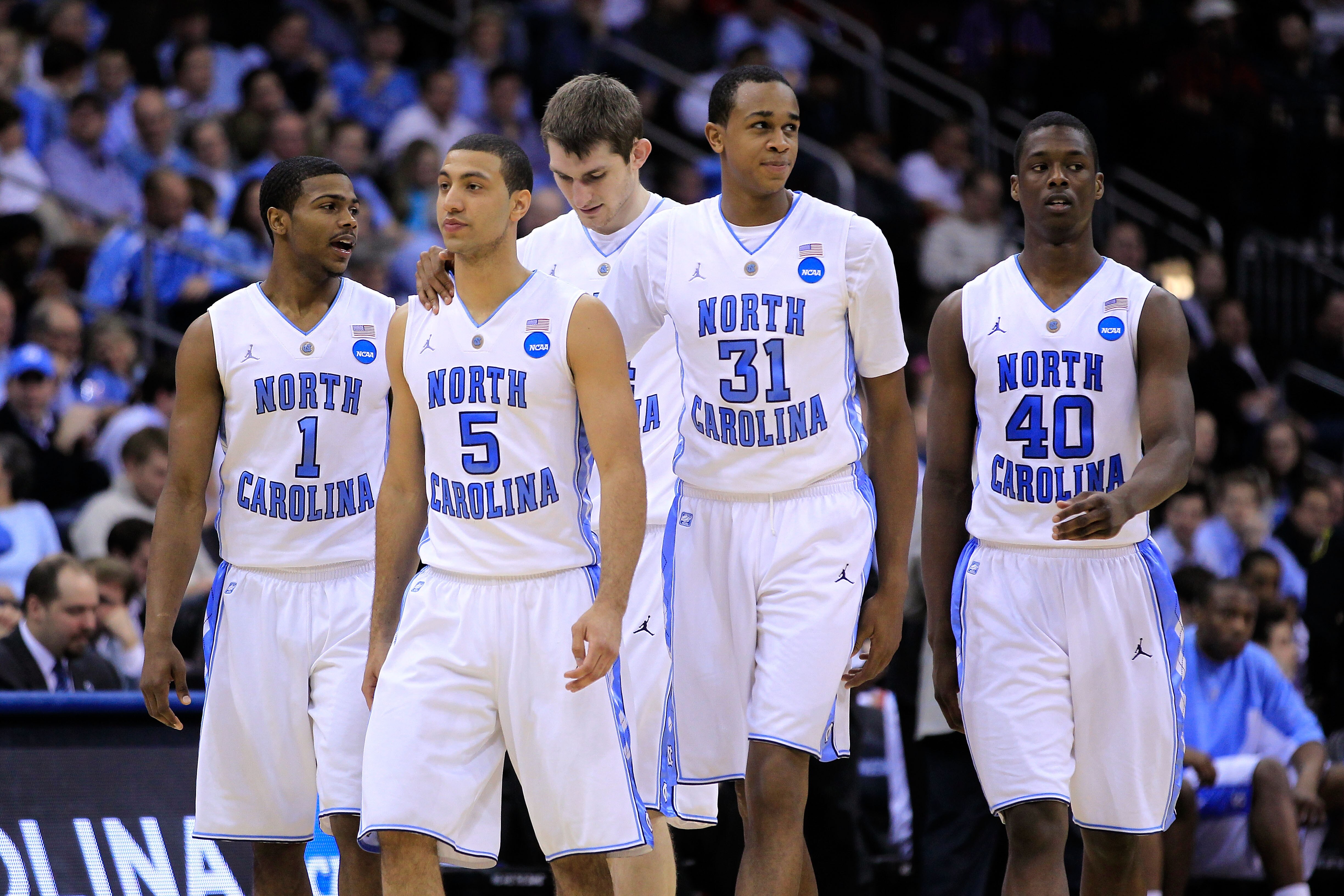 NEWARK, NJ - MARCH 25:  Dexter Strickland #1, Kendall Marshall #5, John Henson #31 and Harrison Barnes #40  of the North Carolina Tar Heels walk on the court after a play against the Marquette Golden Eagles during the east regional semifinal of the 2011 N