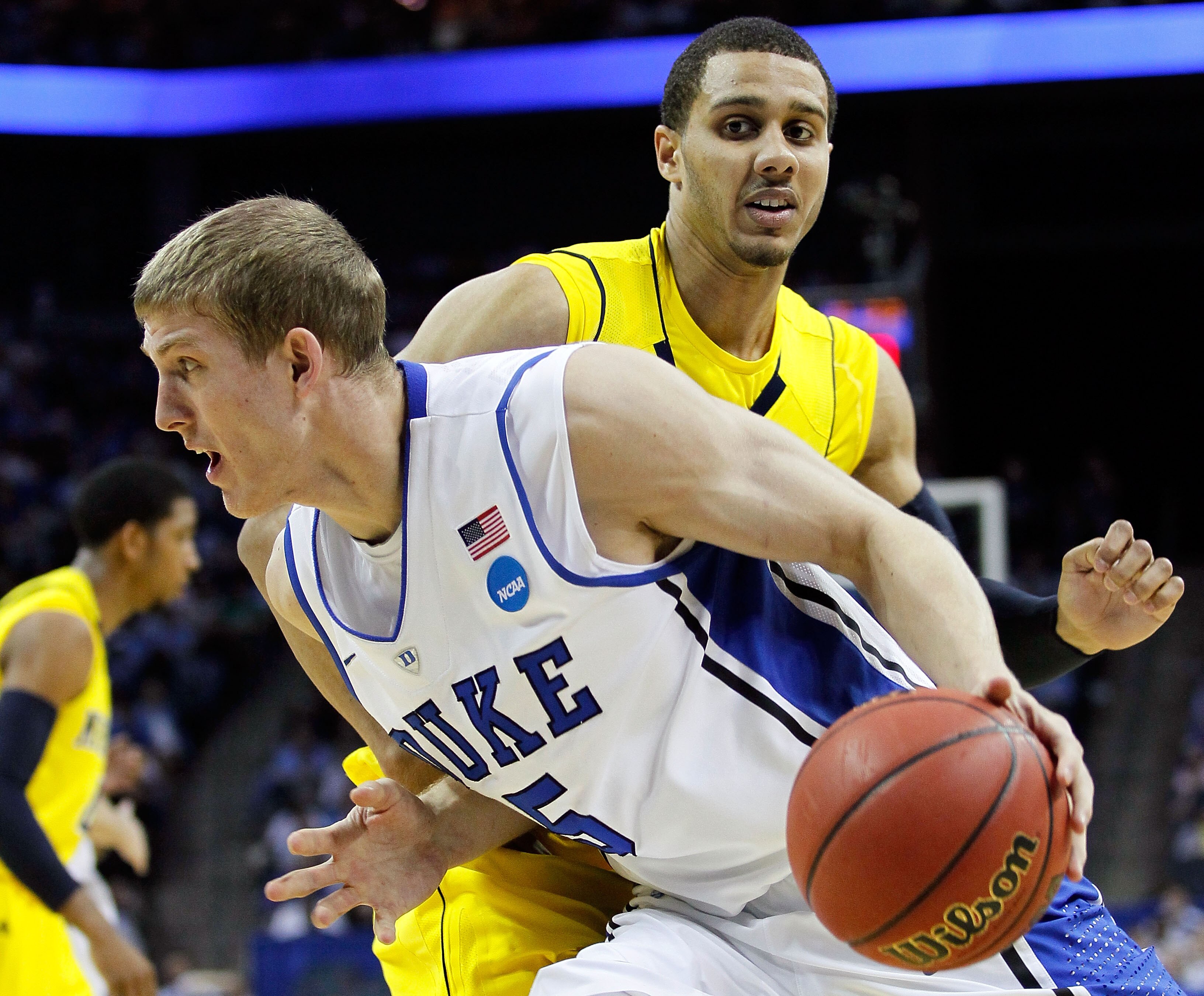 CHARLOTTE, NC - MARCH 20:  Mason Plumlee #5 of the Duke Blue Devils drives on Jordan Morgan #52 of the Michigan Wolverines in the first half during the third round of the 2011 NCAA men's basketball tournament at Time Warner Cable Arena on March 20, 2011 i