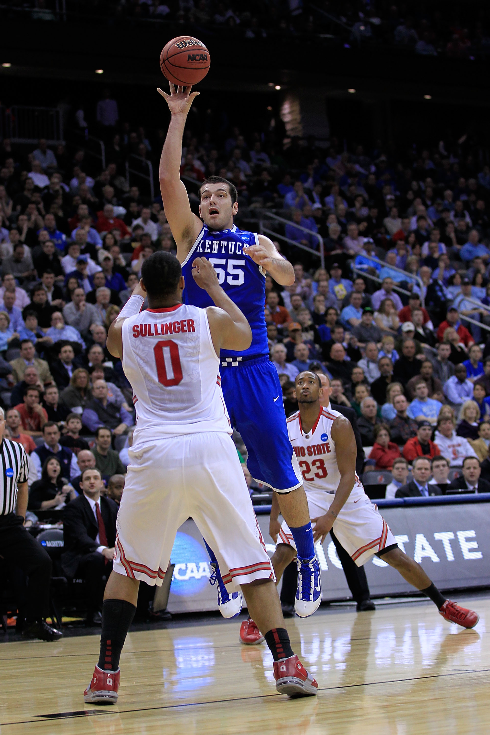 NEWARK, NJ - MARCH 25:  Josh Harrellson #55 of the Kentucky Wildcats takes a shot against Jared Sullinger #0 of the Ohio State Buckeyes during the first half of the east regional semifinal of the 2011 NCAA Men's Basketball Tournament at the Prudential Cen