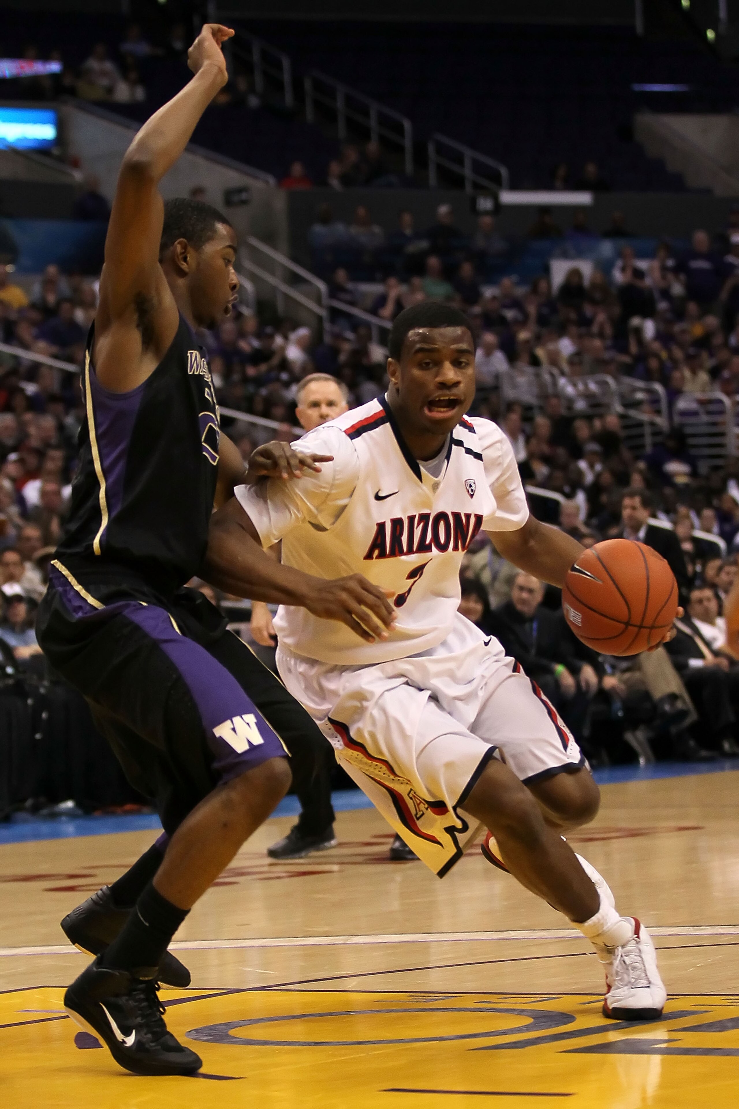 LOS ANGELES, CA - MARCH 12: Kevin Parrom #3 of the Arizona Wildcats drives the ball against the Washington Huskies in the championship game of the 2011 Pacific Life Pac-10 Men's Basketball Tournament at Staples Center on March 12, 2011 in Los Angeles, Ca LOS ANGELES, CA - MARCH 12: Kevin Parrom #3 of the Arizona Wildcats drives the ball against the Washington Huskies in the championship game of the 2011 Pacific Life Pac-10 Men's Basketball Tournament at Staples Center on March 12, 2011 in Los Angeles, Ca