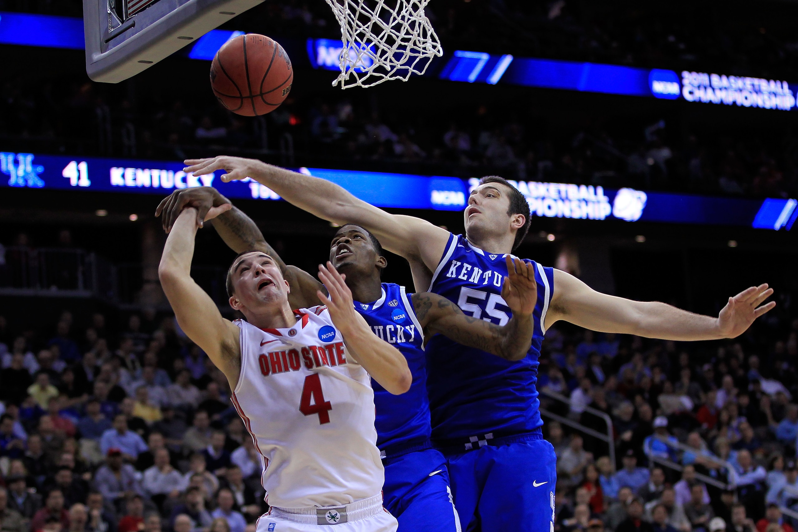 NEWARK, NJ - MARCH 25:  Josh Harrellson #55 of the Kentucky Wildcats blocks a shot of Aaron Craft #4 of the Ohio State Buckeyes during the east regional semifinal of the 2011 NCAA Men's Basketball Tournament at the Prudential Center on March 25, 2011 in N