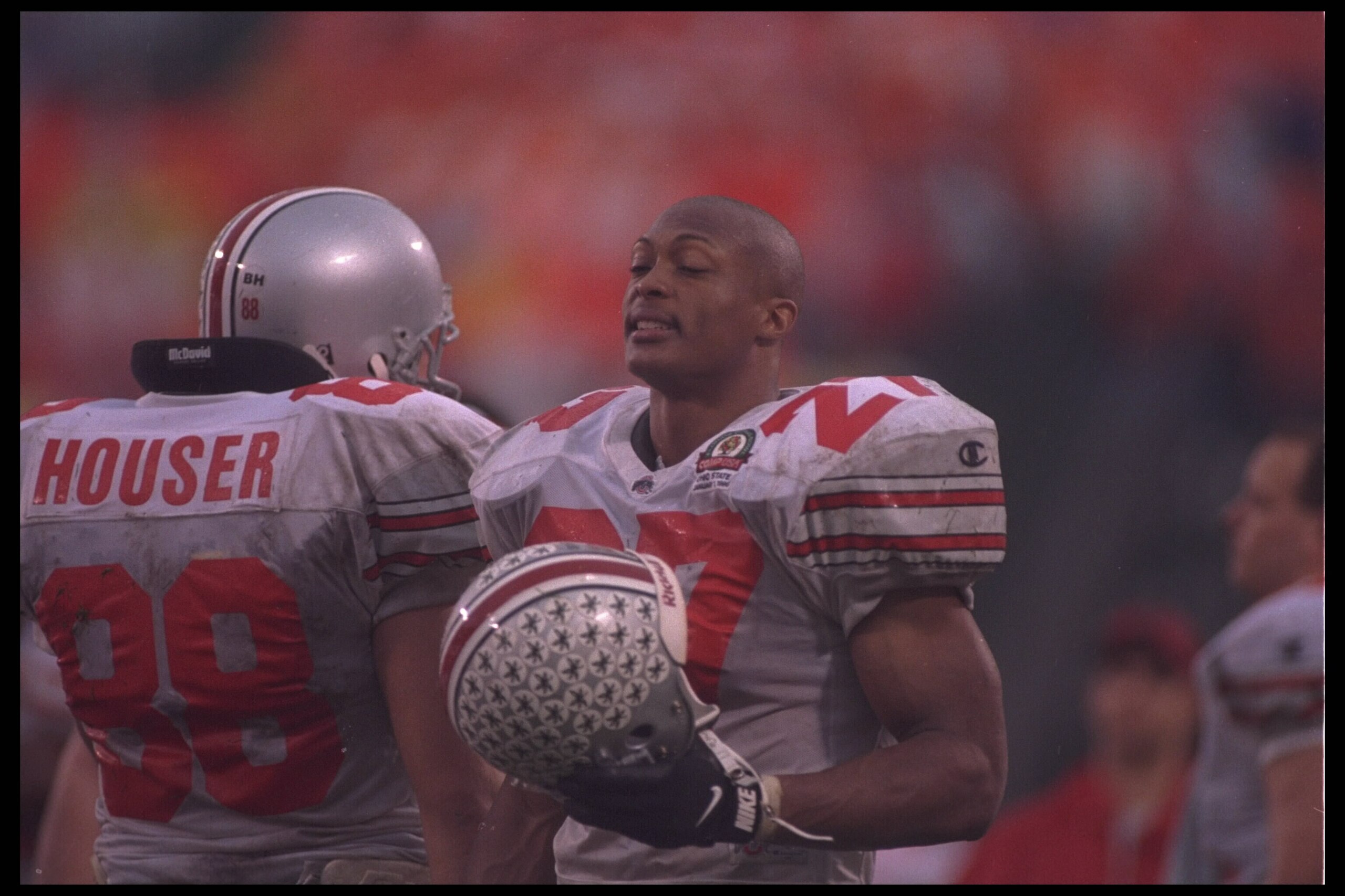 1 Jan 1996:  Tailback Eddie George #27 of the Ohio State Buckeyes takes off his helmet for a rest on the sideline with Bob Houser #88 during the game against the Tennessee Volunteers in the Citrus Bowl in Orlando, Florida.  Tennessee defeated Ohio State 2