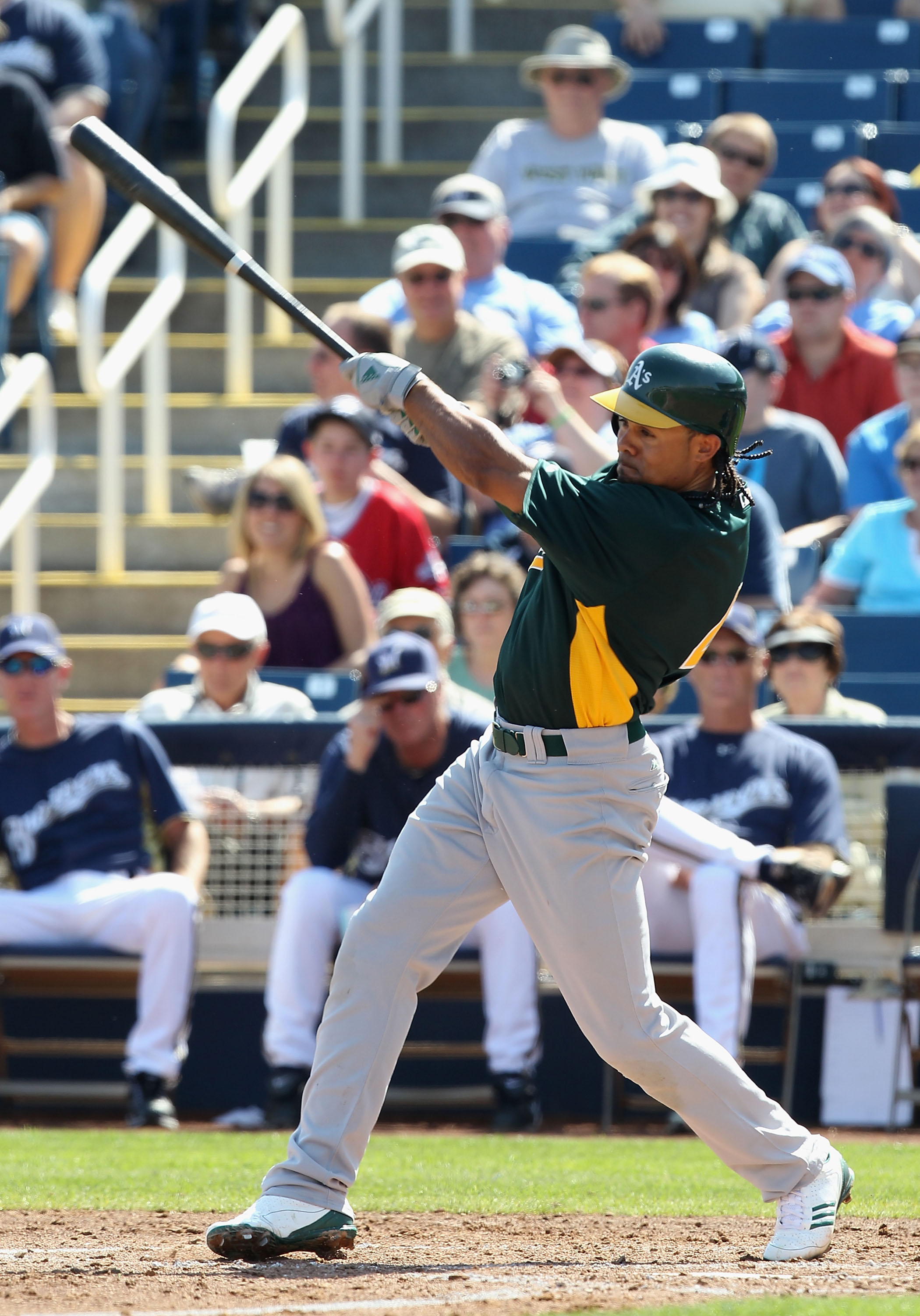 PHOENIX, AZ - MARCH 03:  Coco Crisp #4 of the Oakland Athletics hits a RBI single against the Milwaukee Brewers during the second inning of the spring training game at Maryvale Baseball Park on March 3, 2011 in Phoenix, Arizona.  (Photo by Christian Peter