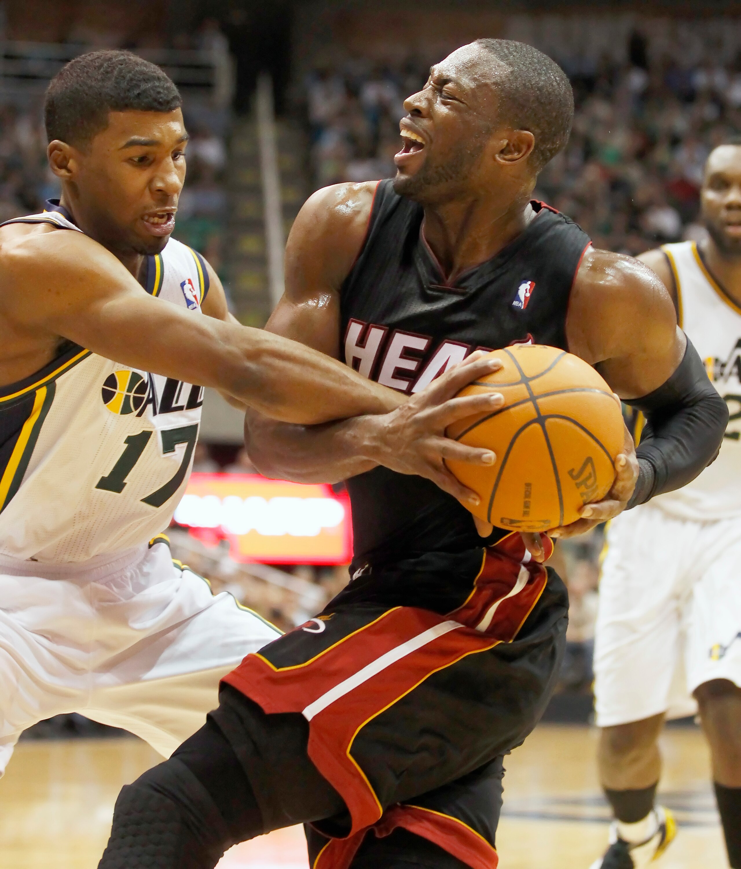 SALT LAKE CITY, UT - DECEMBER 8: Dwyane Wade #3 of Miami Heat is fouled by Ronnie Price #17 of Utah Jazz during the first half of an NBA game December 8, 2010 at Energy Solutions Arena in Salt Lake City, Utah. NOTE TO USER:  User expressly acknowledges an