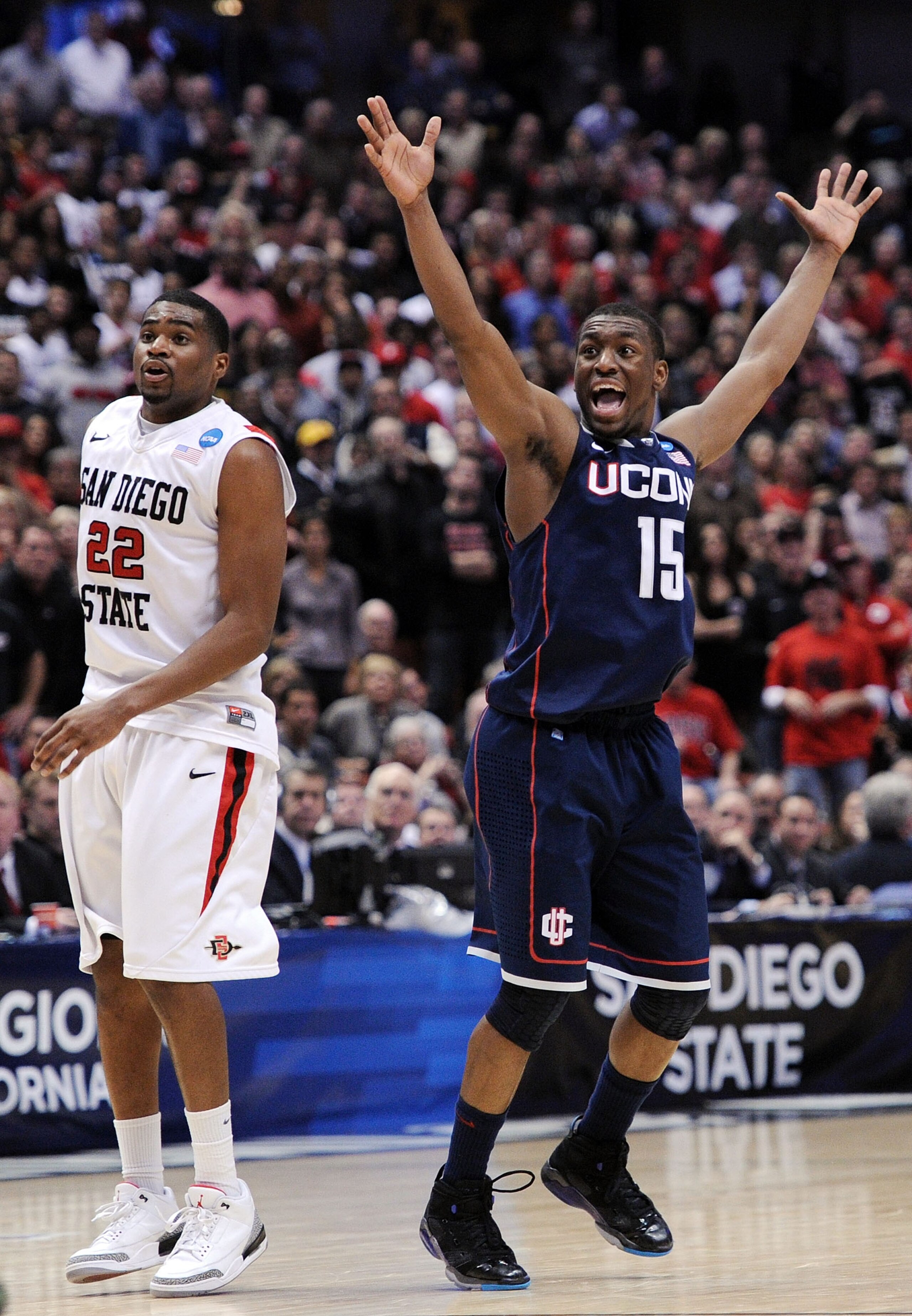 ANAHEIM, CA - MARCH 24: Kemba Walker #15 of the Connecticut Huskies reacts after making a play late in the game as Chase Tapley #22 of the San Diego State Aztecs looks on during the west regional semifinal of the 2011 NCAA men's basketball tournament at ANAHEIM, CA - MARCH 24: Kemba Walker #15 of the Connecticut Huskies reacts after making a play late in the game as Chase Tapley #22 of the San Diego State Aztecs looks on during the west regional semifinal of the 2011 NCAA men's basketball tournament at