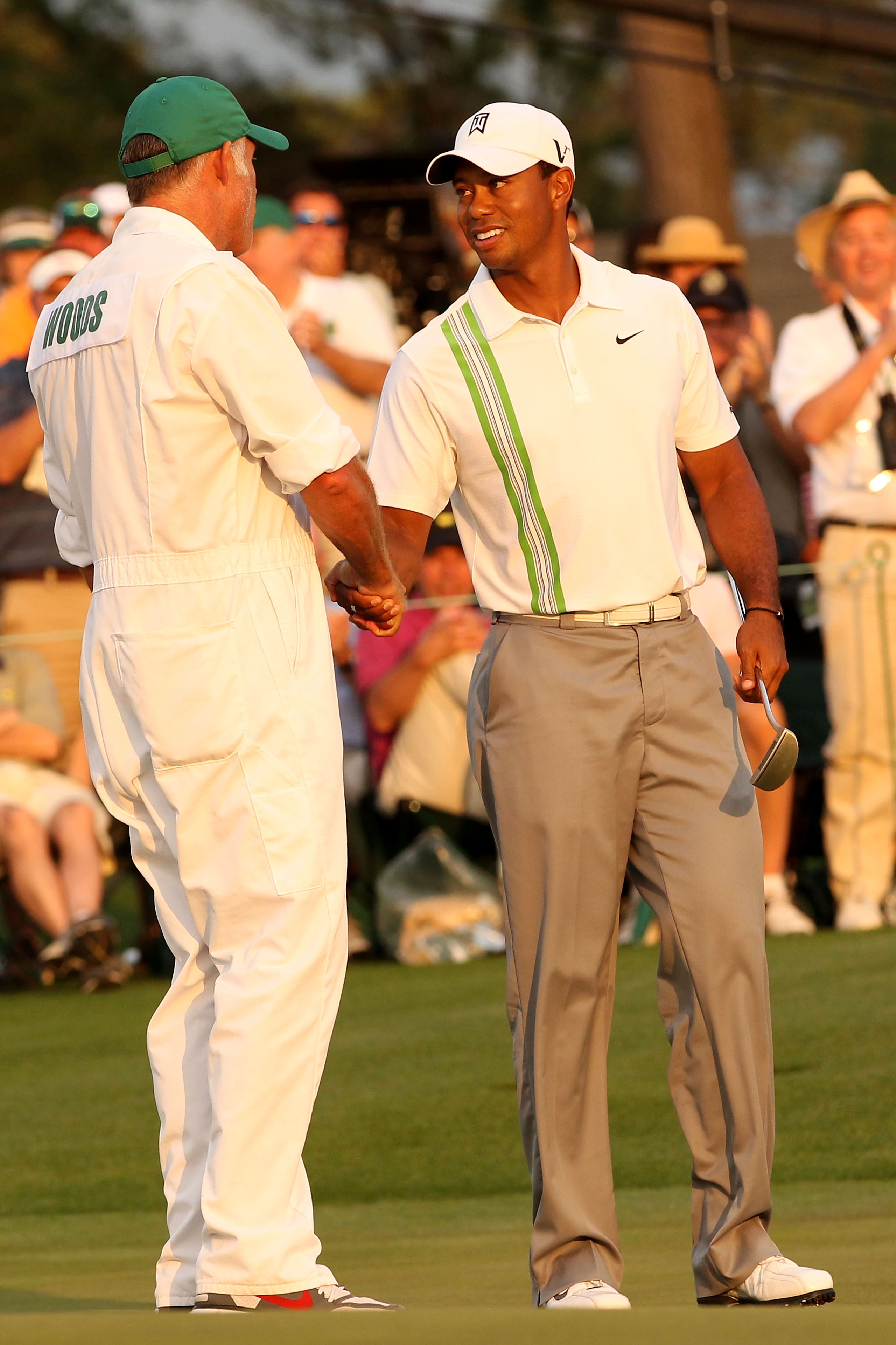 AUGUSTA, GA - APRIL 08:  Tiger Woods (R) shakes hands with his caddie Steve Williams on the 18th green after his six-under par 66 during the second round of the 2011 Masters Tournament at Augusta National Golf Club on April 8, 2011 in Augusta, Georgia.  (