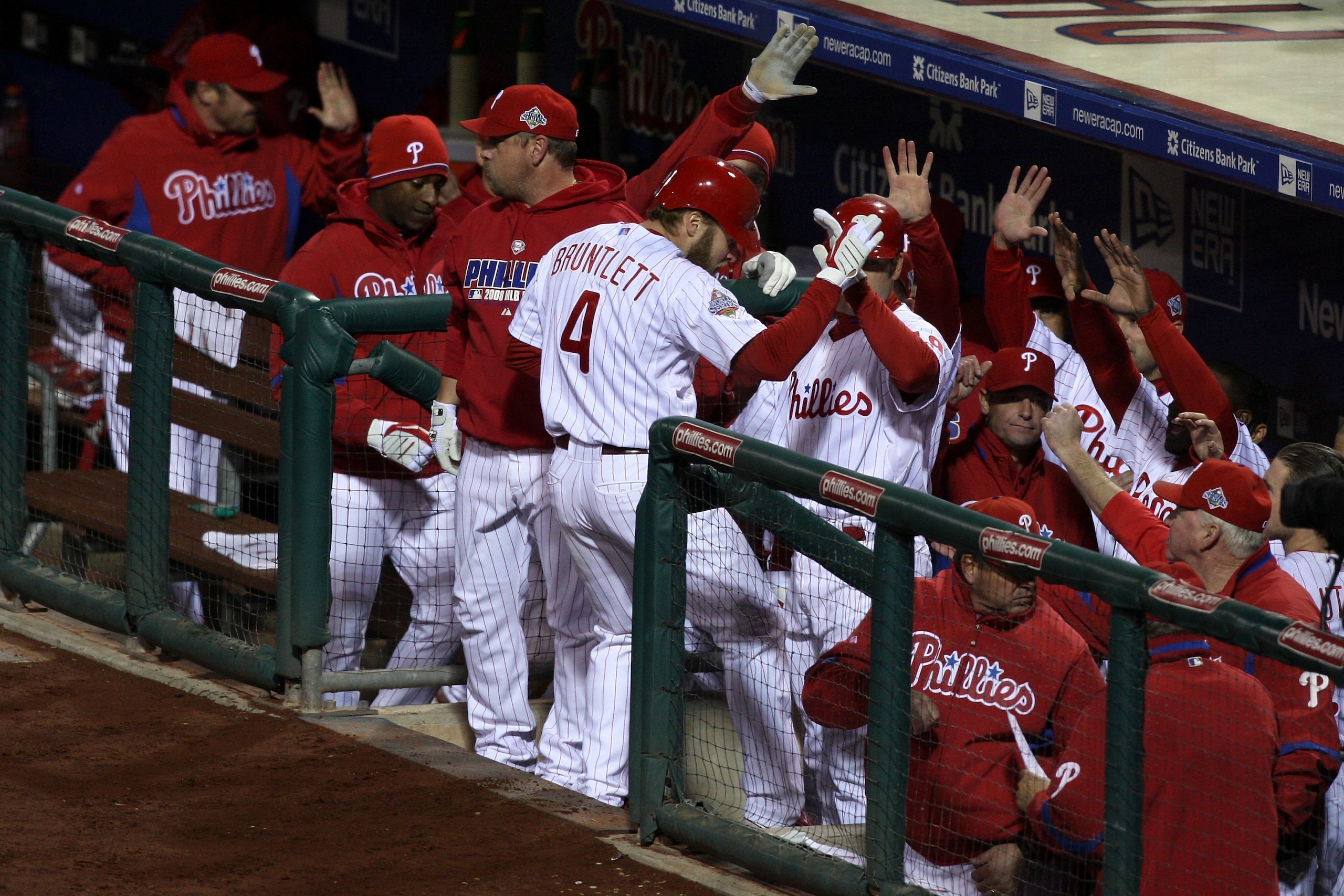PHILADELPHIA - OCTOBER 29:  Eric Bruntlett #4 of the Philadelphia Phillies celebrates with teammates after he scored on a RBI single by Pedro Feliz in the bottom of the seventh inning against the Tampa Bay Rays during the continuation of game five of the