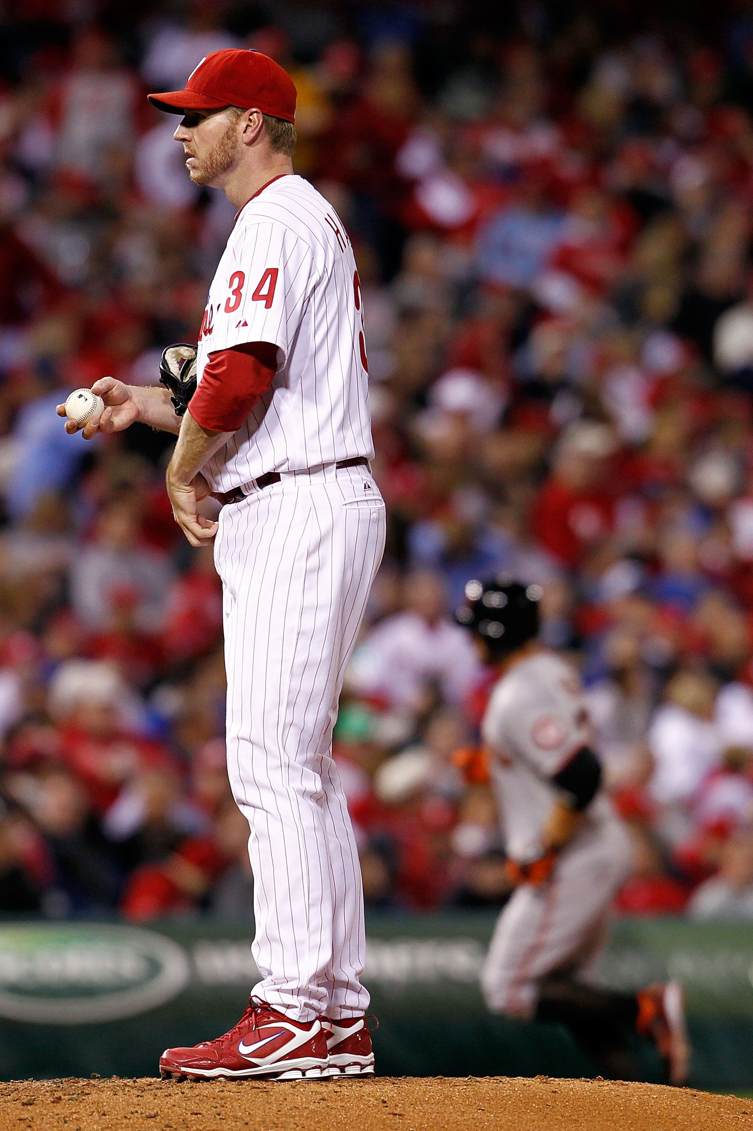 PHILADELPHIA - OCTOBER 16:  (L-R) Roy Halladay #34 of the Philadelphia Phillies looks on as Cody Ross #13 of the San Francisco Giants rounds the bases after a fifth inning home run in Game One of the NLCS during the 2010 MLB Playoffs at Citizens Bank Park