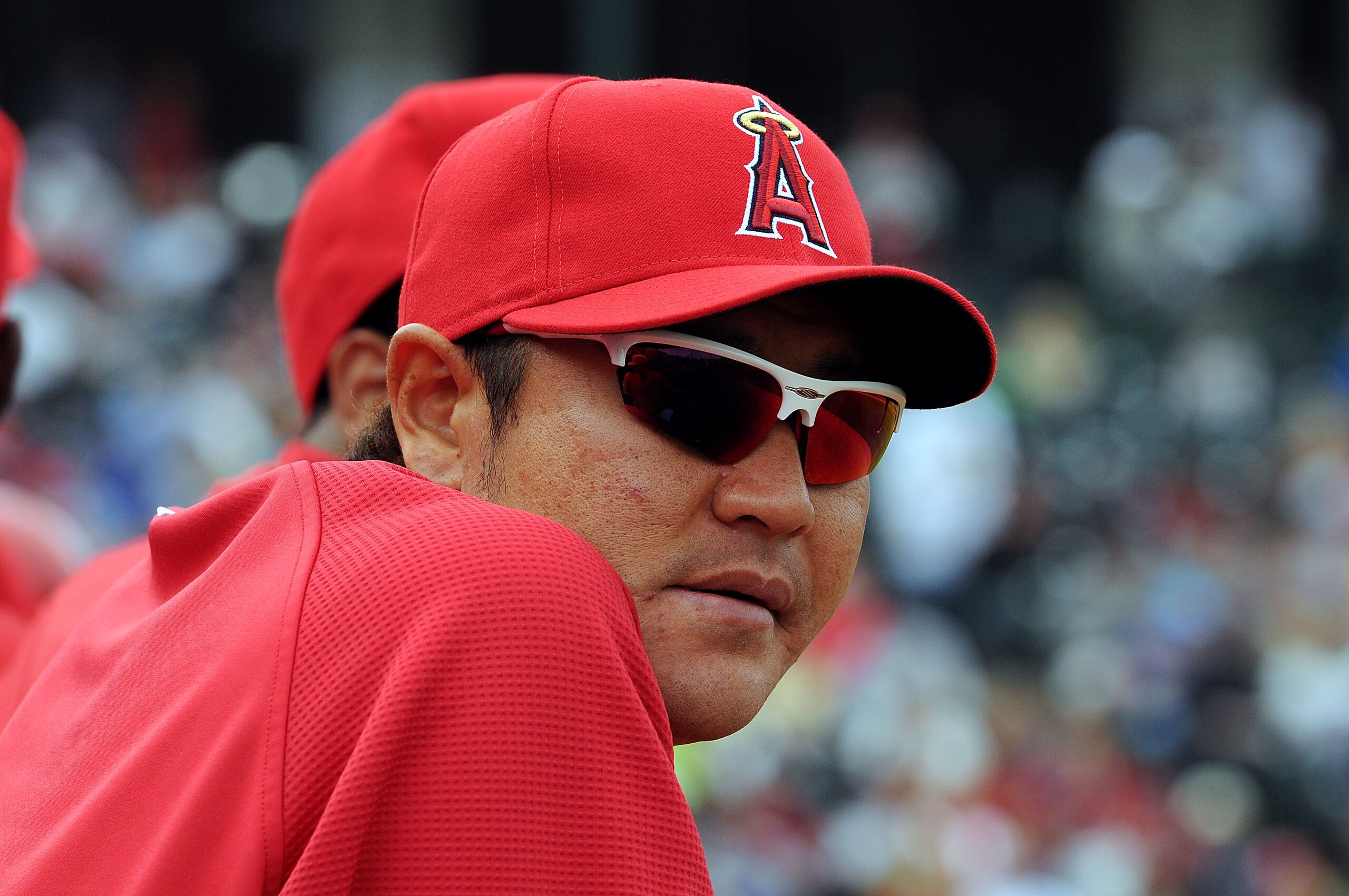 TEMPE, AZ - FEBRUARY 26:  Hisanori Takahashi #21 of the Los Angeles Angels of Anaheim watches from the bench during a game against the Los Angeles Dodgers at Tempe Diablo Stadium on February 26, 2011 in Tempe, Arizona.  (Photo by Norm Hall/Getty Images)