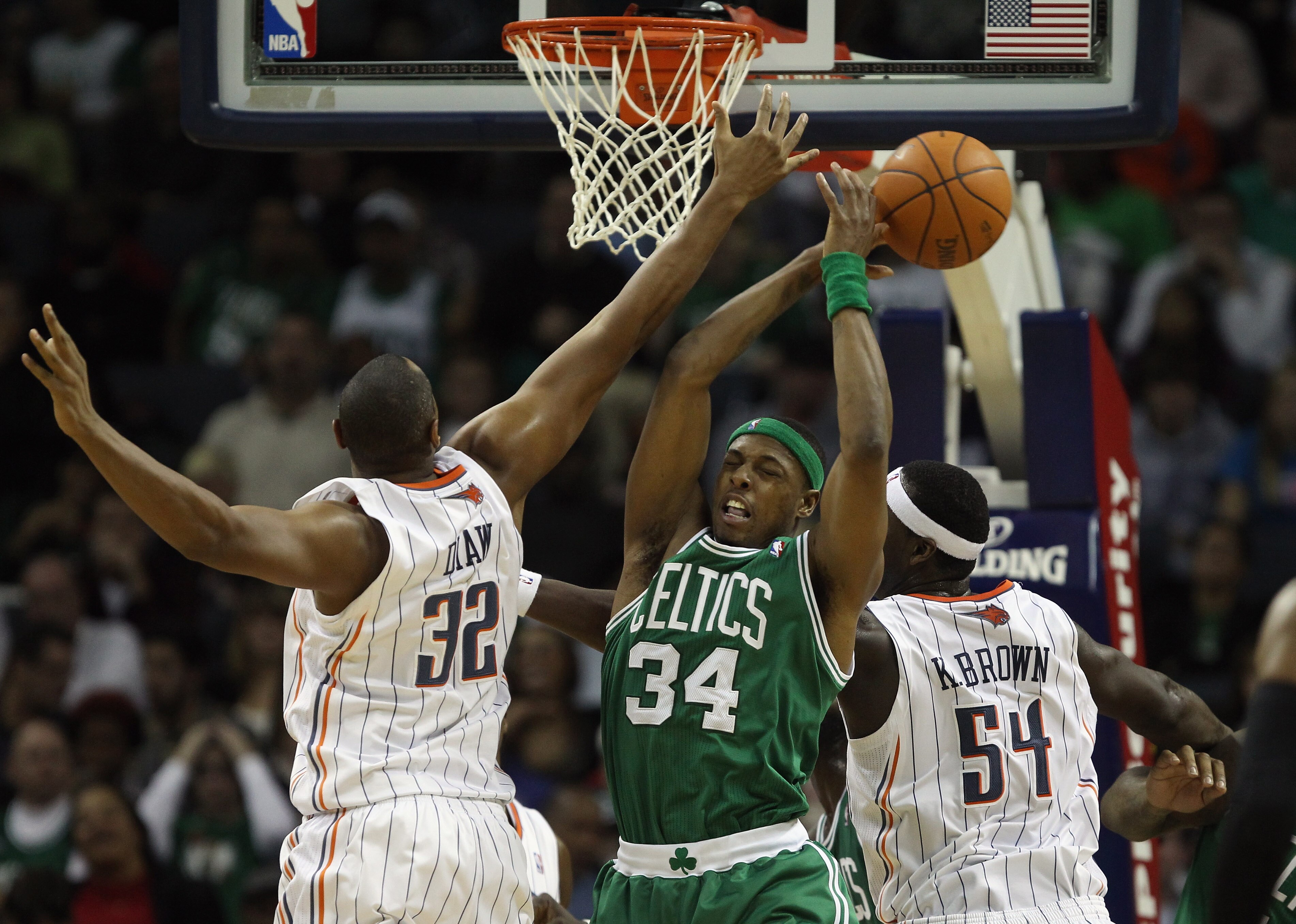 CHARLOTTE, NC - DECEMBER 11:  Paul Pierce #34 of the Boston Celtics battles for a loose ball with teammates Boris Diaw #32 and Kwame Brown #54 of the Charlotte Bobcats during their game at Time Warner Cable Arena on December 11, 2010 in Charlotte, North C