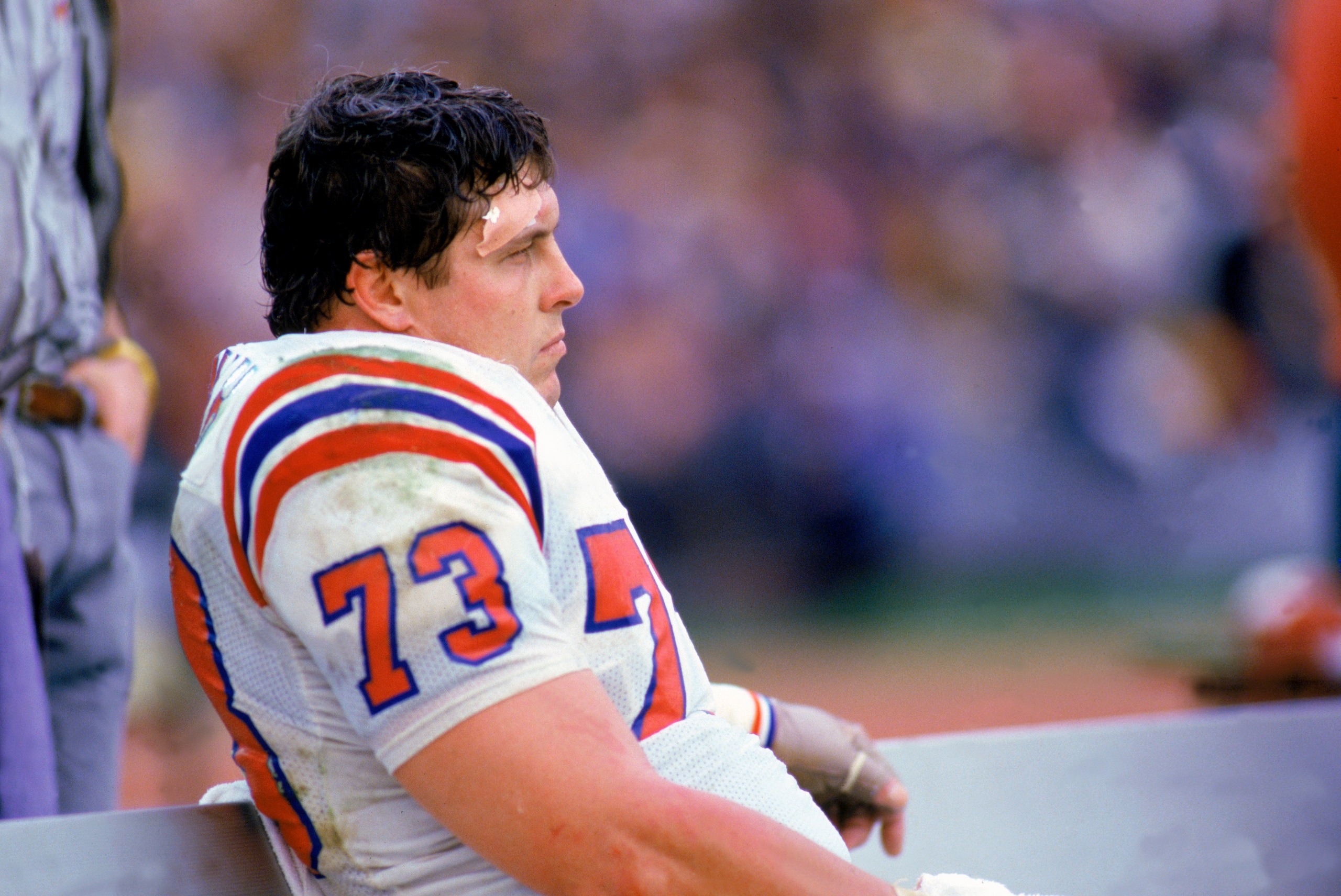 1985:  Offensive linebacker John Hannah #73 of the New England Patriots sits on the sideline during a 1985 NFL game.  (Photo by Rick Stewart/Getty Images)