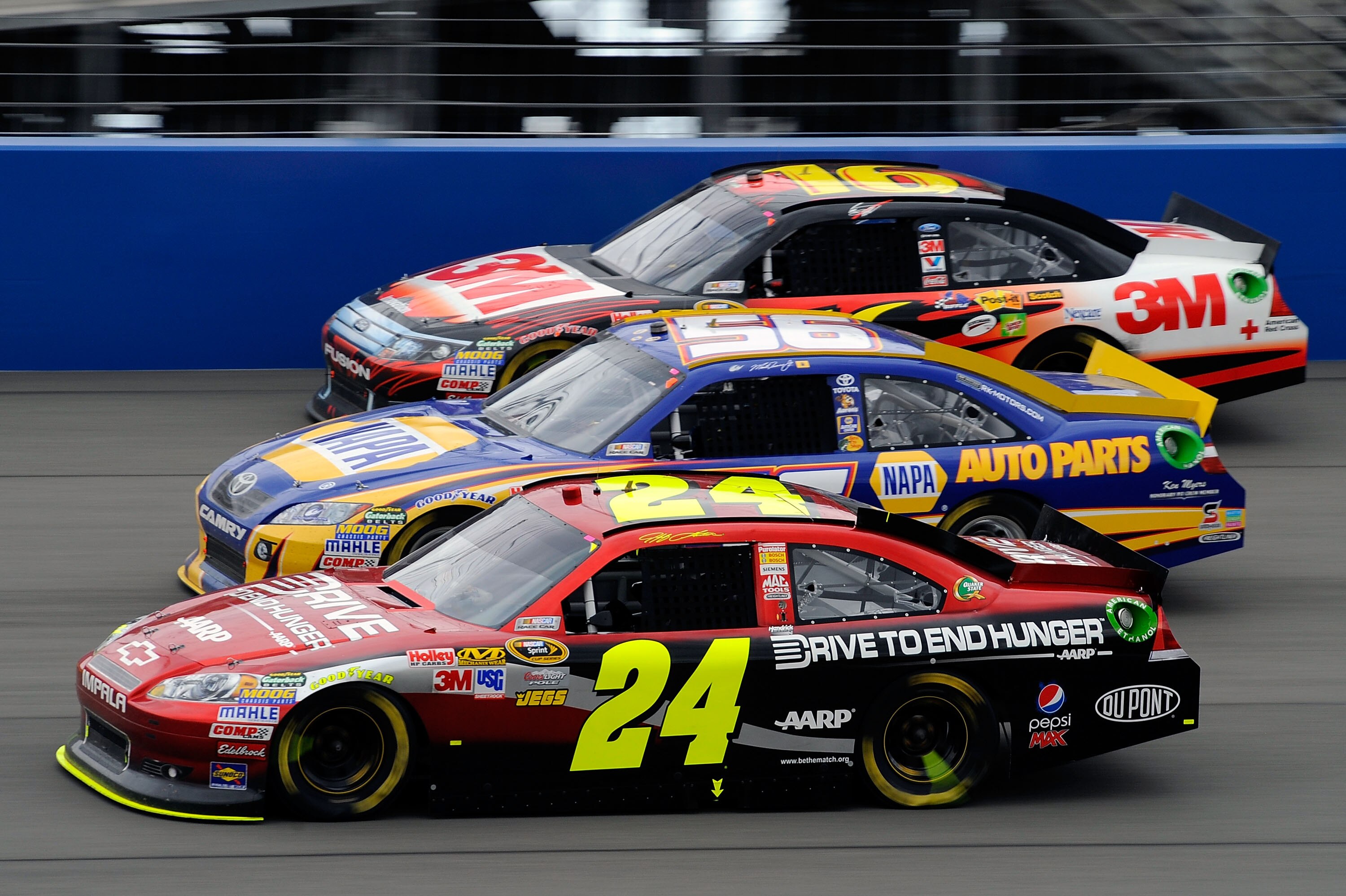 FONTANA, CA - MARCH 27:  Jeff Gordon, driver of the #24 Drive to End Hunger Chevrolet, races Martin Truex Jr., driver of the #56 NAPA Toyota, and Greg Biffle, driver of the #16 3M Ford, during the NASCAR Sprint Cup Series Auto Club 400 at Auto Club Speedw