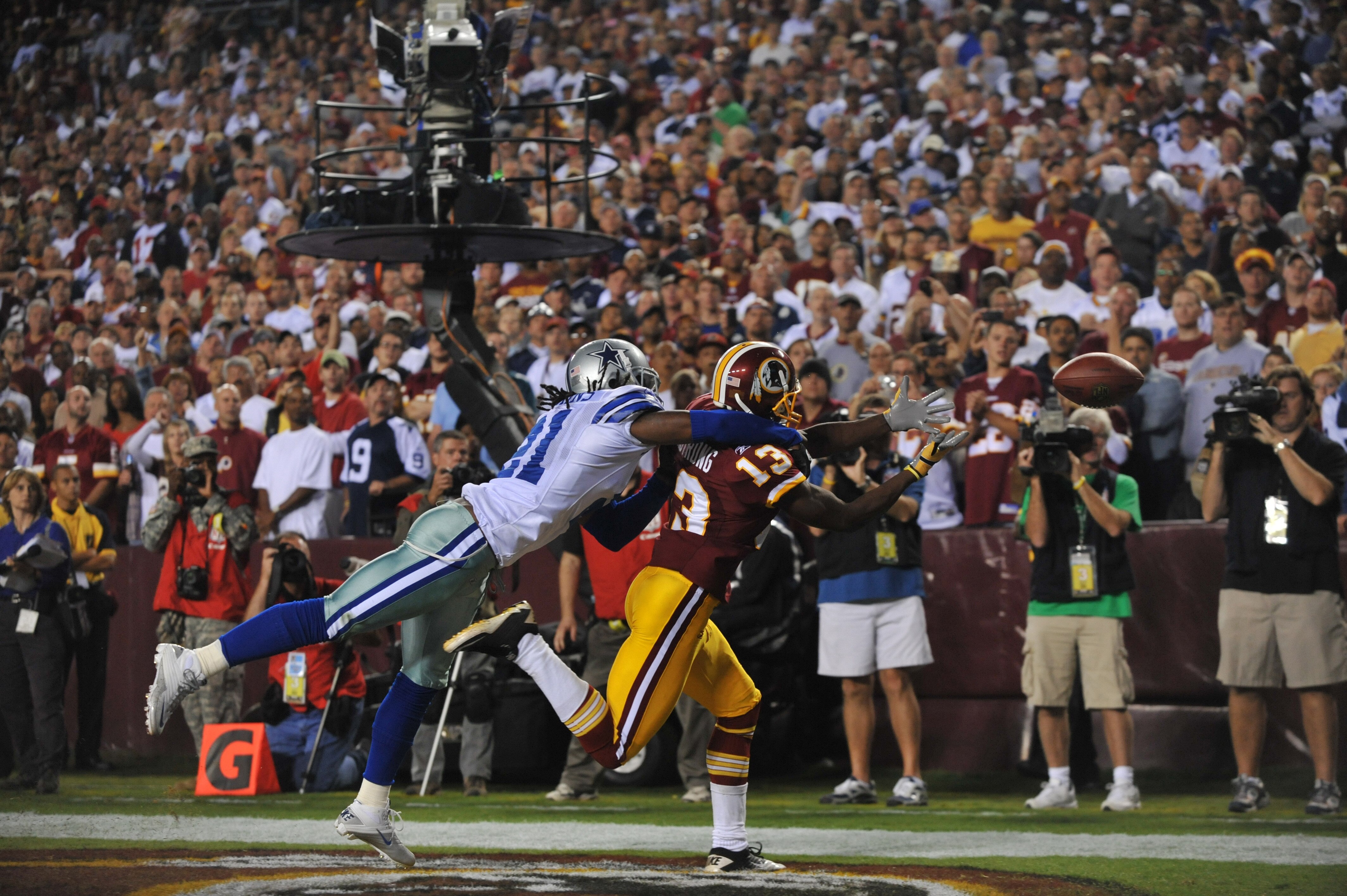 LANDOVER - SEPTEMBER 12: Mike Jenkins #21 of the Dallas Cowboys knocks the ball loose from Anthony Armstrong #13 of the Washington Redskins during the NFL season opener at FedExField on September 12, 2010 in Landover, Maryland. The Redskins defeated the LANDOVER - SEPTEMBER 12: Mike Jenkins #21 of the Dallas Cowboys knocks the ball loose from Anthony Armstrong #13 of the Washington Redskins during the NFL season opener at FedExField on September 12, 2010 in Landover, Maryland. The Redskins defeated the