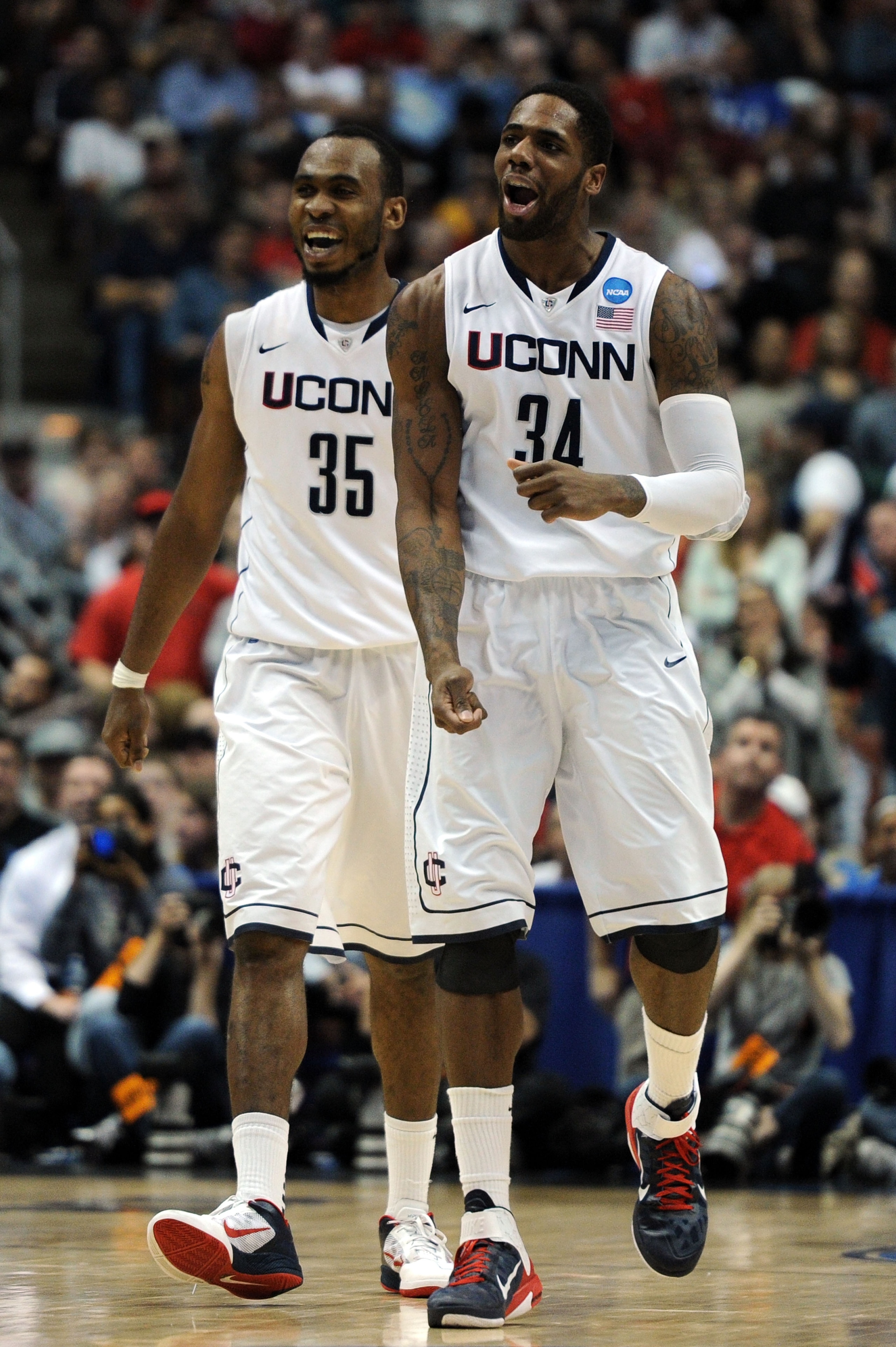 ANAHEIM, CA - MARCH 26:  Alex Oriakhi #34 and Charles Okwandu #35 of the Connecticut Huskies celebrate after a play against the Arizona Wildcats during the west regional final of the 2011 NCAA men's basketball tournament at the Honda Center on March 26, 2