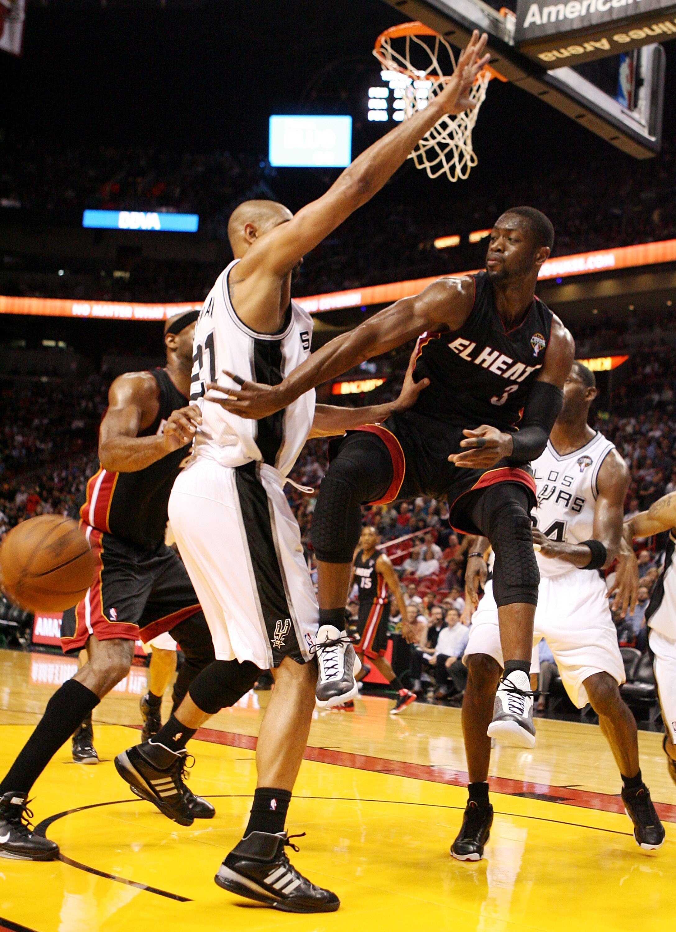 MIAMI - MARCH 14: Guard Dwyane Wade #3 of the Miami Heat passes against Center Tim Duncan #21 of the San Antonio Spurs at American Airlines Arena on March 14, 2011 in Miami, Florida. NOTE TO USER: User expressly acknowledges and agrees that, by download MIAMI - MARCH 14: Guard Dwyane Wade #3 of the Miami Heat passes against Center Tim Duncan #21 of the San Antonio Spurs at American Airlines Arena on March 14, 2011 in Miami, Florida. NOTE TO USER: User expressly acknowledges and agrees that, by download