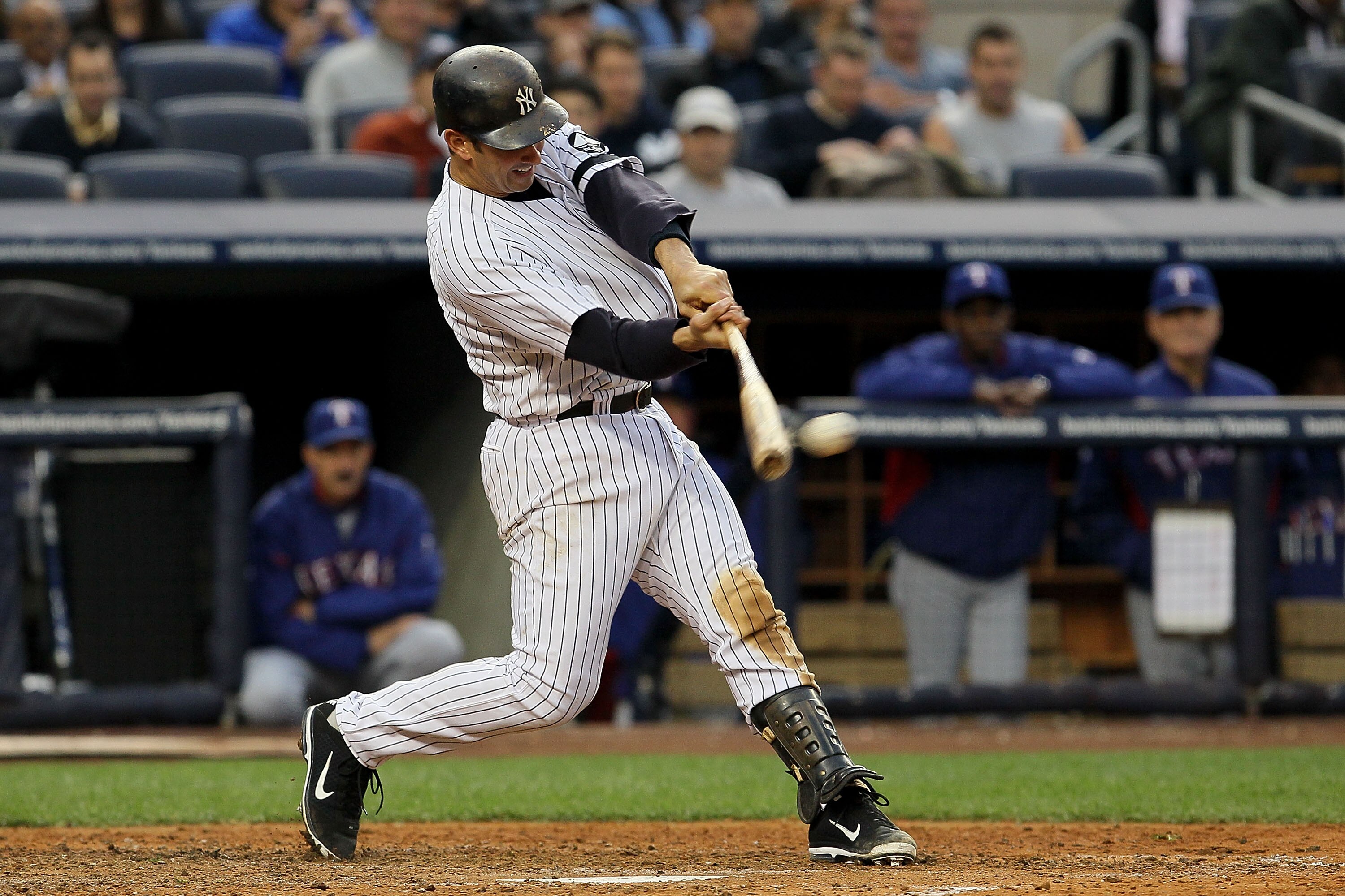 NEW YORK - OCTOBER 20:  Jorge Posada #20 of the New York Yankees hits a double against the Texas Rangers in Game Five of the ALCS during the 2010 MLB Playoffs at Yankee Stadium on October 20, 2010 in the Bronx borough of New York City.  (Photo by Jim McIs