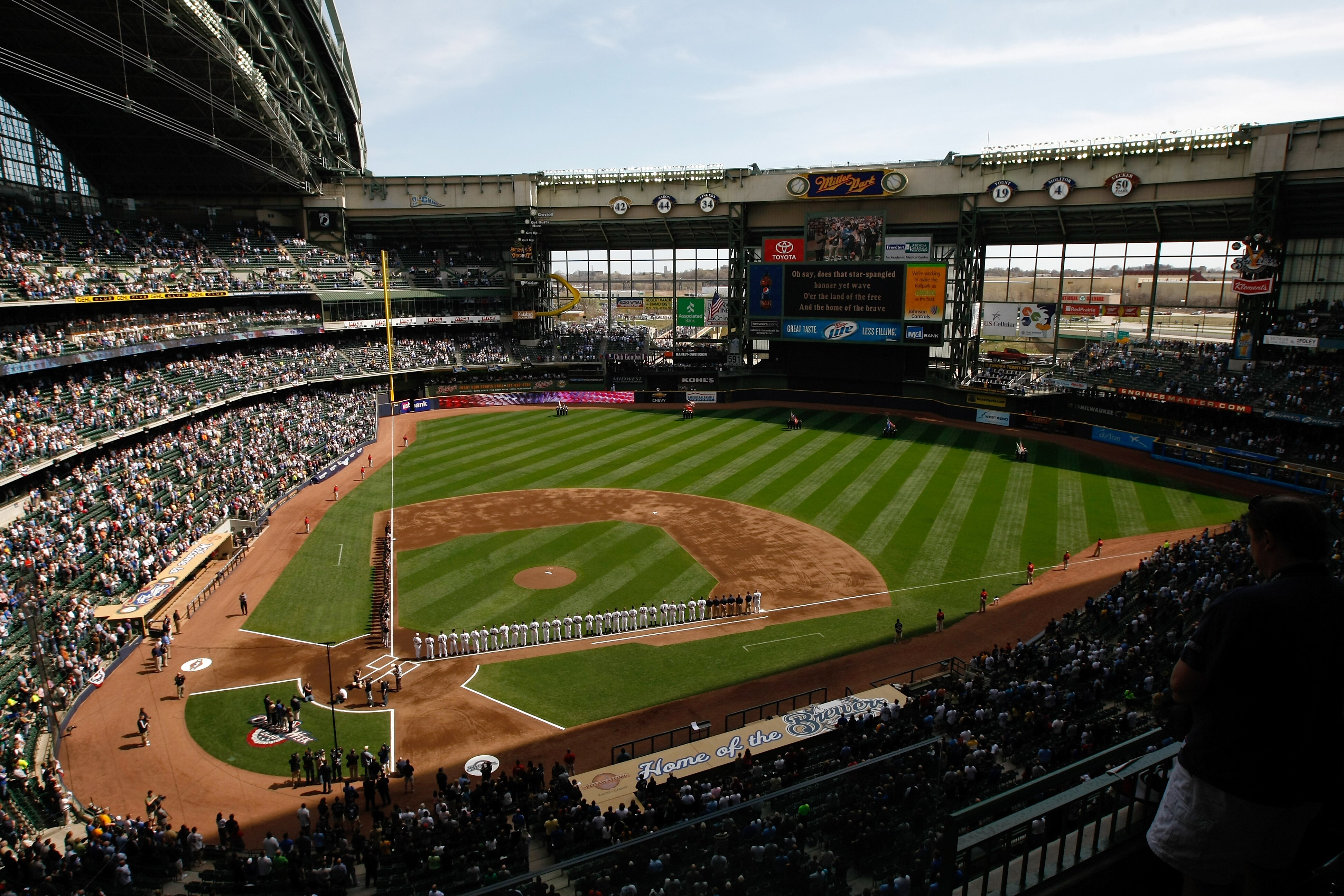 MILWAUKEE, WI - APRIL 05: The Colorado Rockies and Milwaukee Brewers line up on the base lines after introductions during the National Anthem prior to the game between the Colorado Rockies against the Milwaukee Brewers at the Miller Park on April 05, 2010