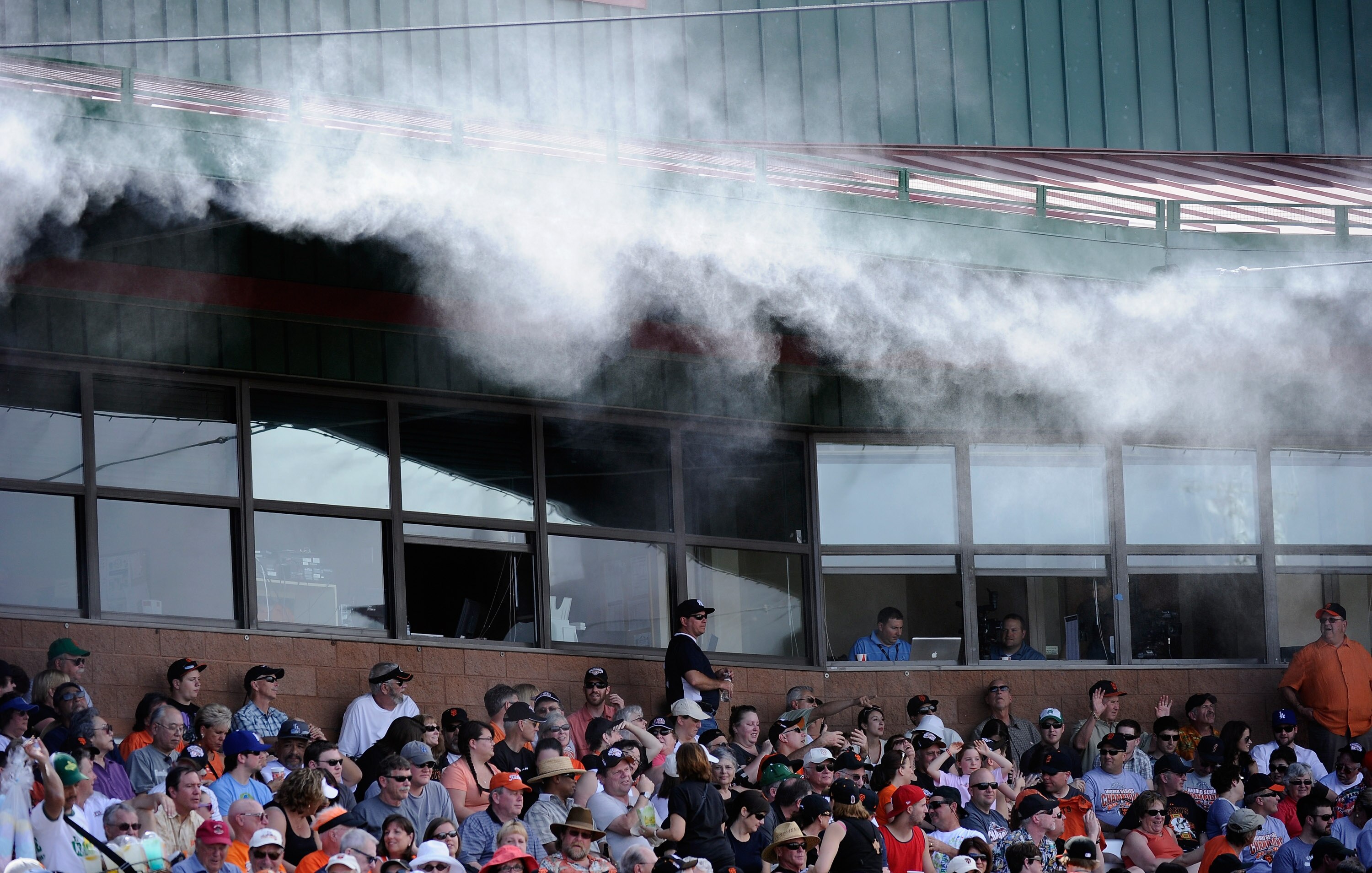 SCOTTSDALE, AZ - MARCH 18:  Mist is sprayed from the roof of the Scottsdale Stadium to keep fans cool during the spring training baseball game of the San Francisco Giants and Los Angeles Dodgers on March 18, 2011 in Scottsdale, Arizona. The temperature du