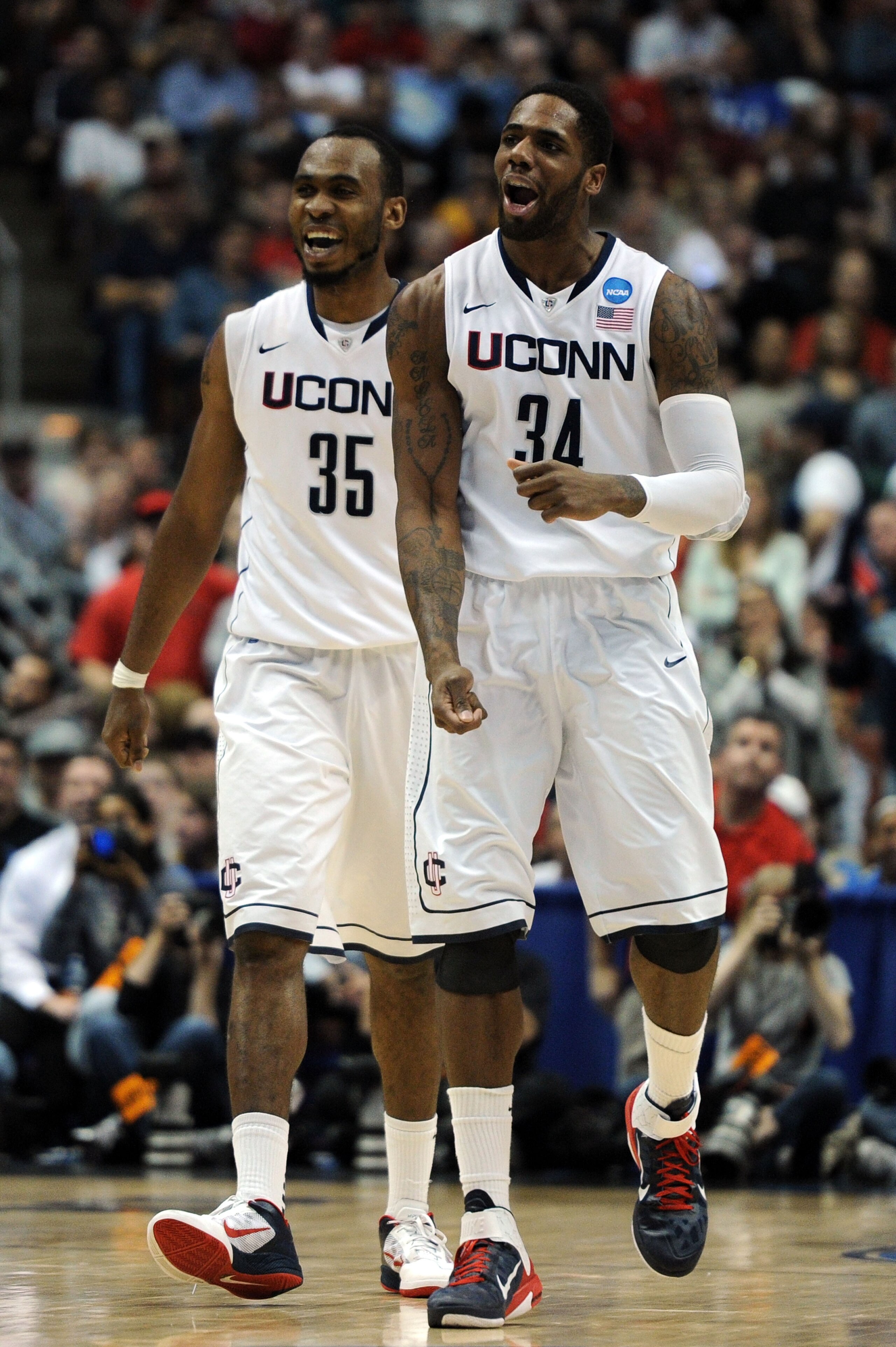 ANAHEIM, CA - MARCH 26:  Alex Oriakhi #34 and Charles Okwandu #35 of the Connecticut Huskies celebrate after a play against the Arizona Wildcats during the west regional final of the 2011 NCAA men's basketball tournament at the Honda Center on March 26, 2