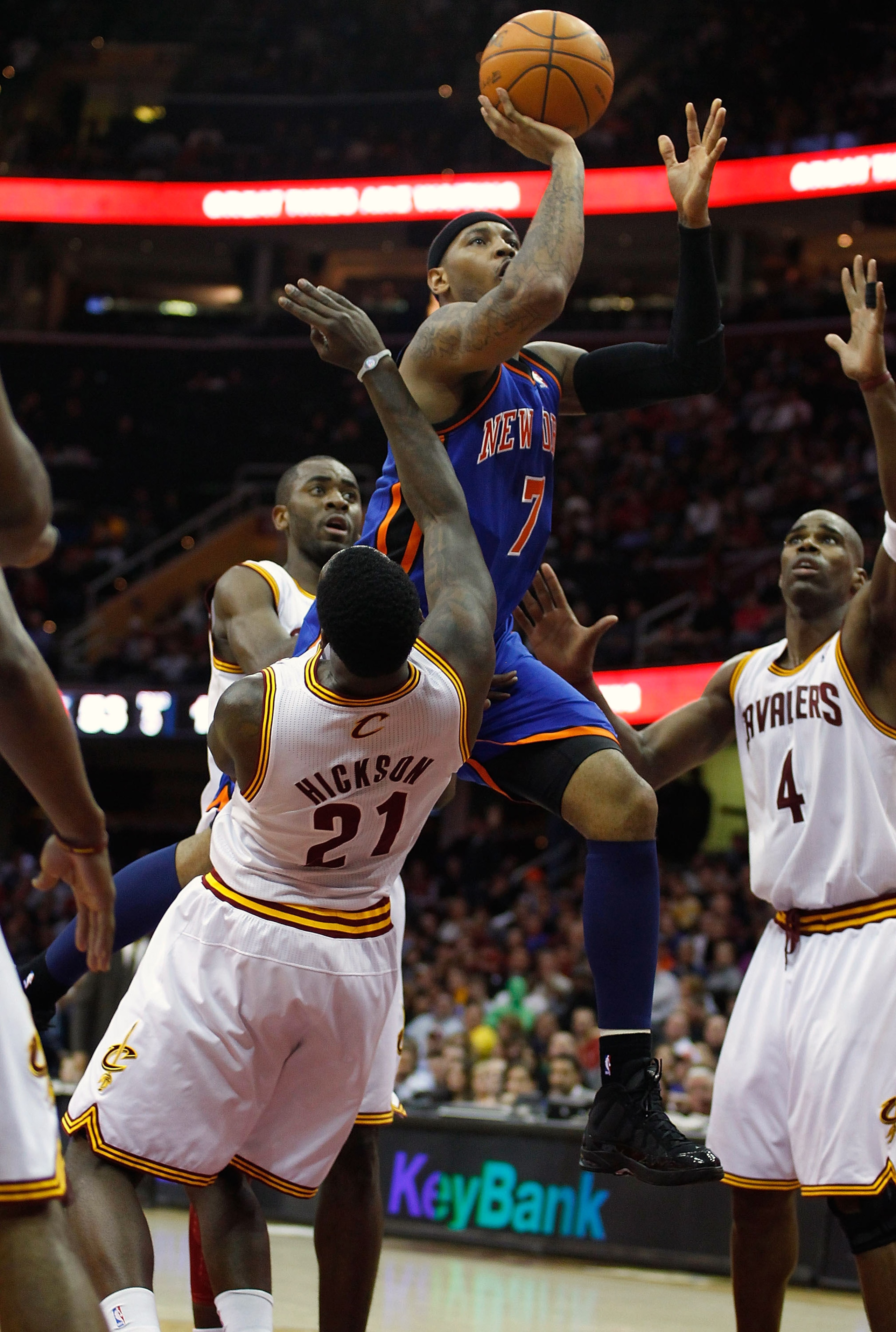 CLEVELAND - FEBRUARY 25:  Carmelo Anthony #7 of the New York Knicks drives to the net in front of J.J. Hickson #21 of the Cleveland Cavaliers on his way to the basket during the game on February 25, 2011 at Quicken Loans Arena in Cleveland, Ohio. NOTE TO