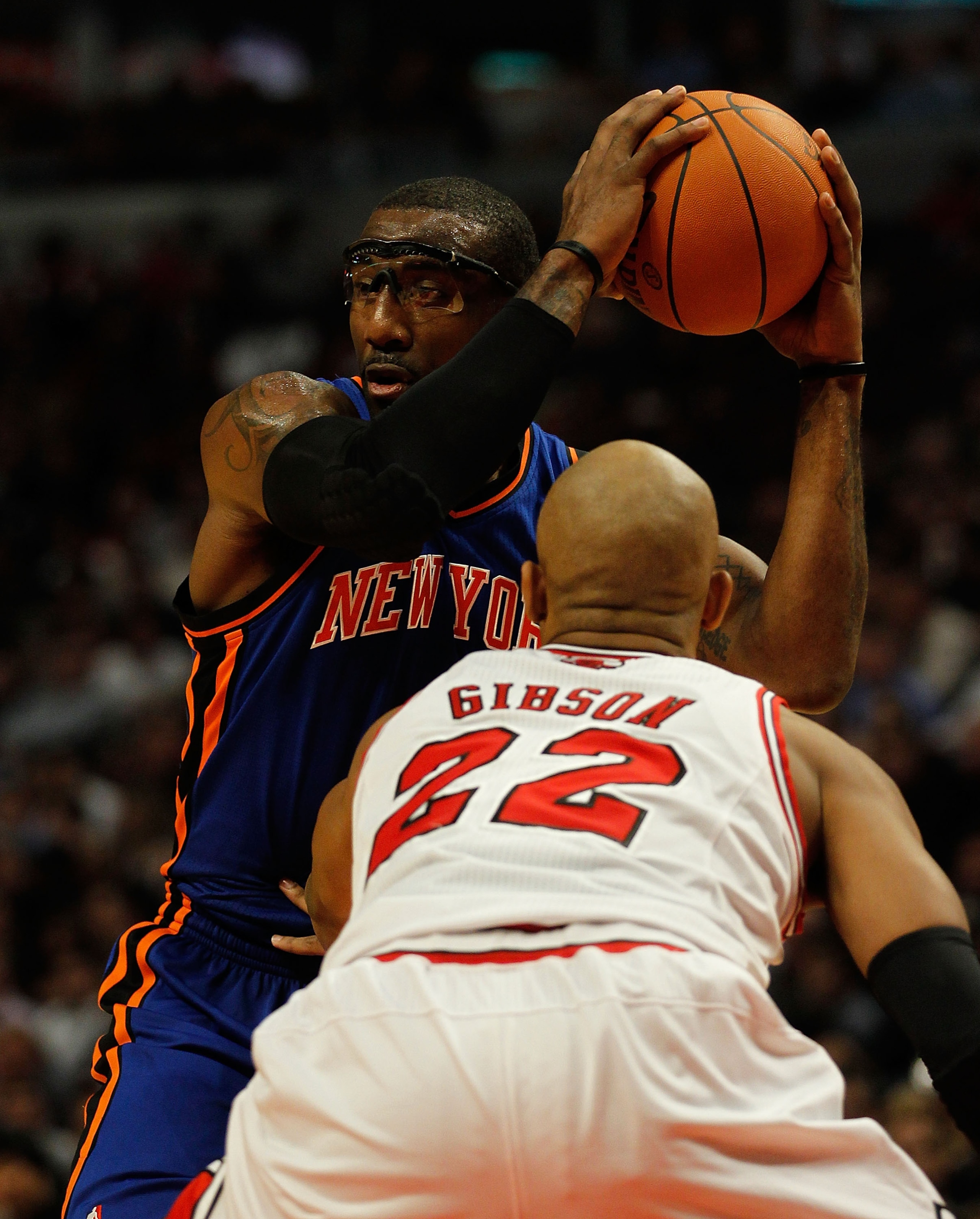 CHICAGO - NOVEMBER 04: Amar'e Stoudemire #1 of the New York Knicks looks to pass under pressure from Taj Gibson #22 of the Chicago Bulls at the United Center on November 4, 2010 in Chicago, Illinois. The Knicks defeated the Bulls 120-112. NOTE TO USER: Us
