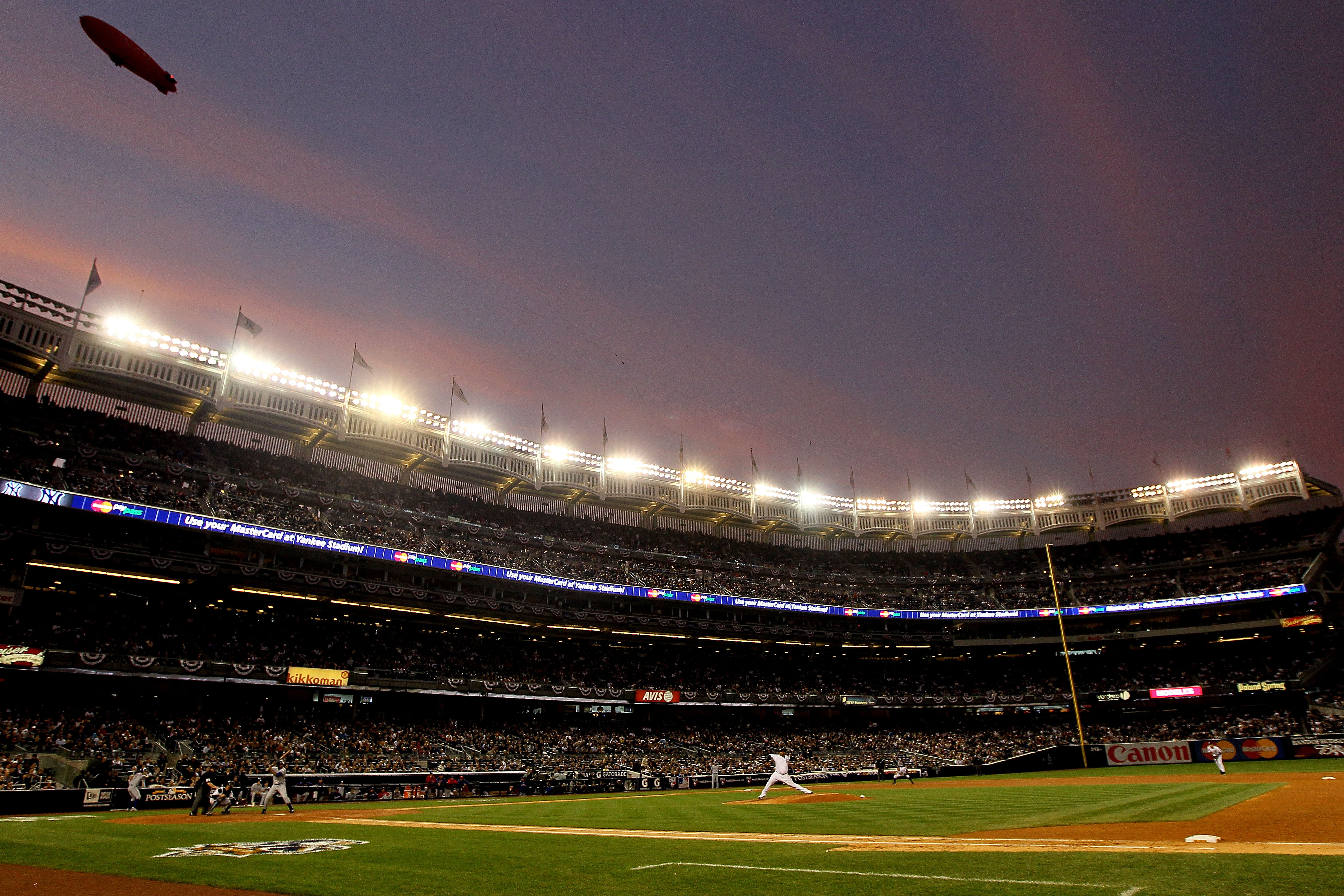 NEW YORK - OCTOBER 20:  CC Sabathia #52 of the New York Yankees pitches against the Texas Rangers in Game Five of the ALCS during the 2010 MLB Playoffs at Yankee Stadium on October 20, 2010 in the Bronx borough of New York City. The Conan blimp is seen fl