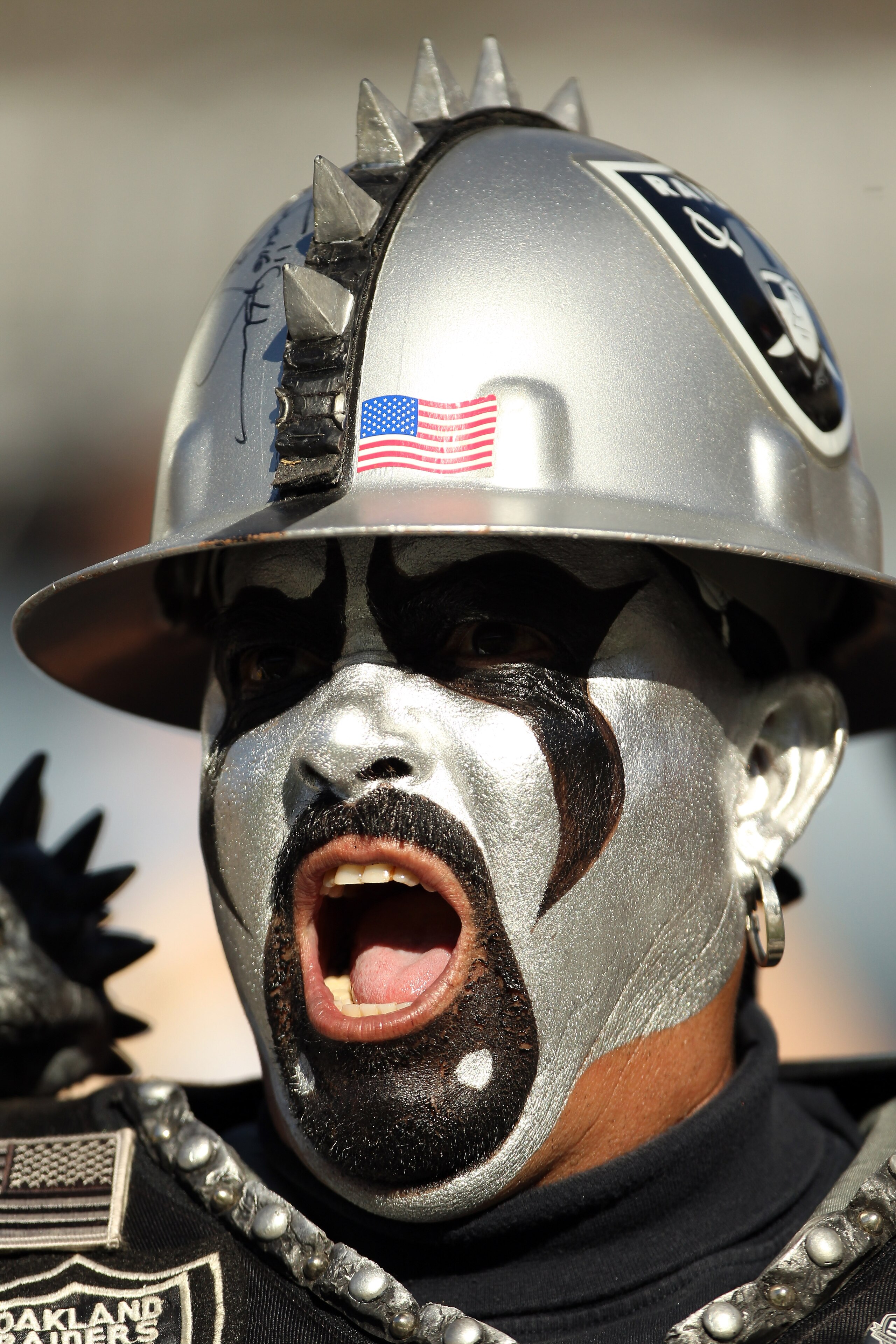 OAKLAND, CA - OCTOBER 10:  An Oakland Raiders fan cheers on his team during their game against the San Diego Chargers at Oakland-Alameda County Coliseum on October 10, 2010 in Oakland, California.  (Photo by Ezra Shaw/Getty Images)