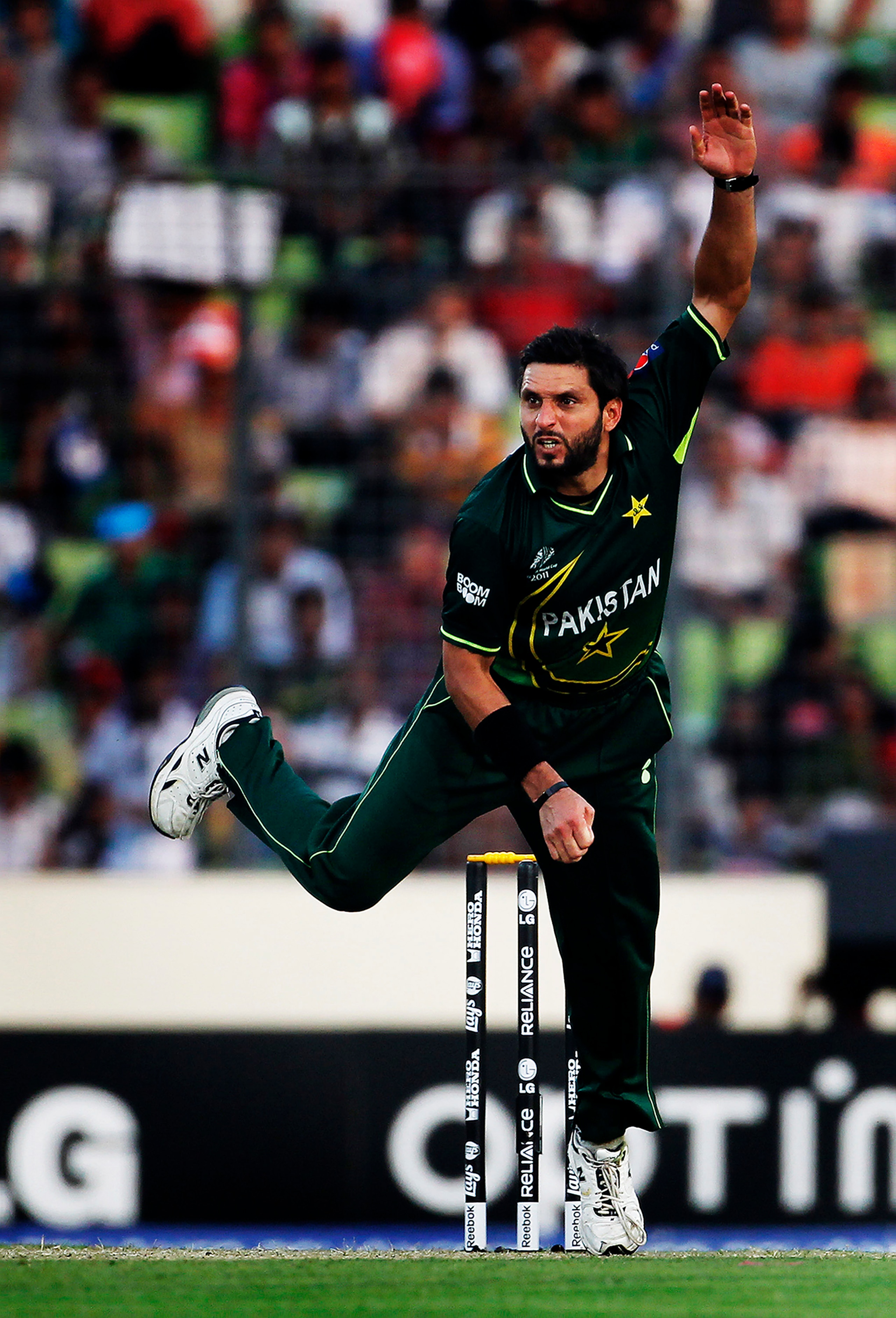 DHAKA, BANGLADESH - MARCH 23:  Shahid Afridi of Pakistan bowls during the 1st quarterfinal of the ICC Cricket World Cup at Shere-e-Bangla National Stadium on March 23, 2011 in Dhaka, Bangladesh.  (Photo by Daniel Berehulak/Getty Images)