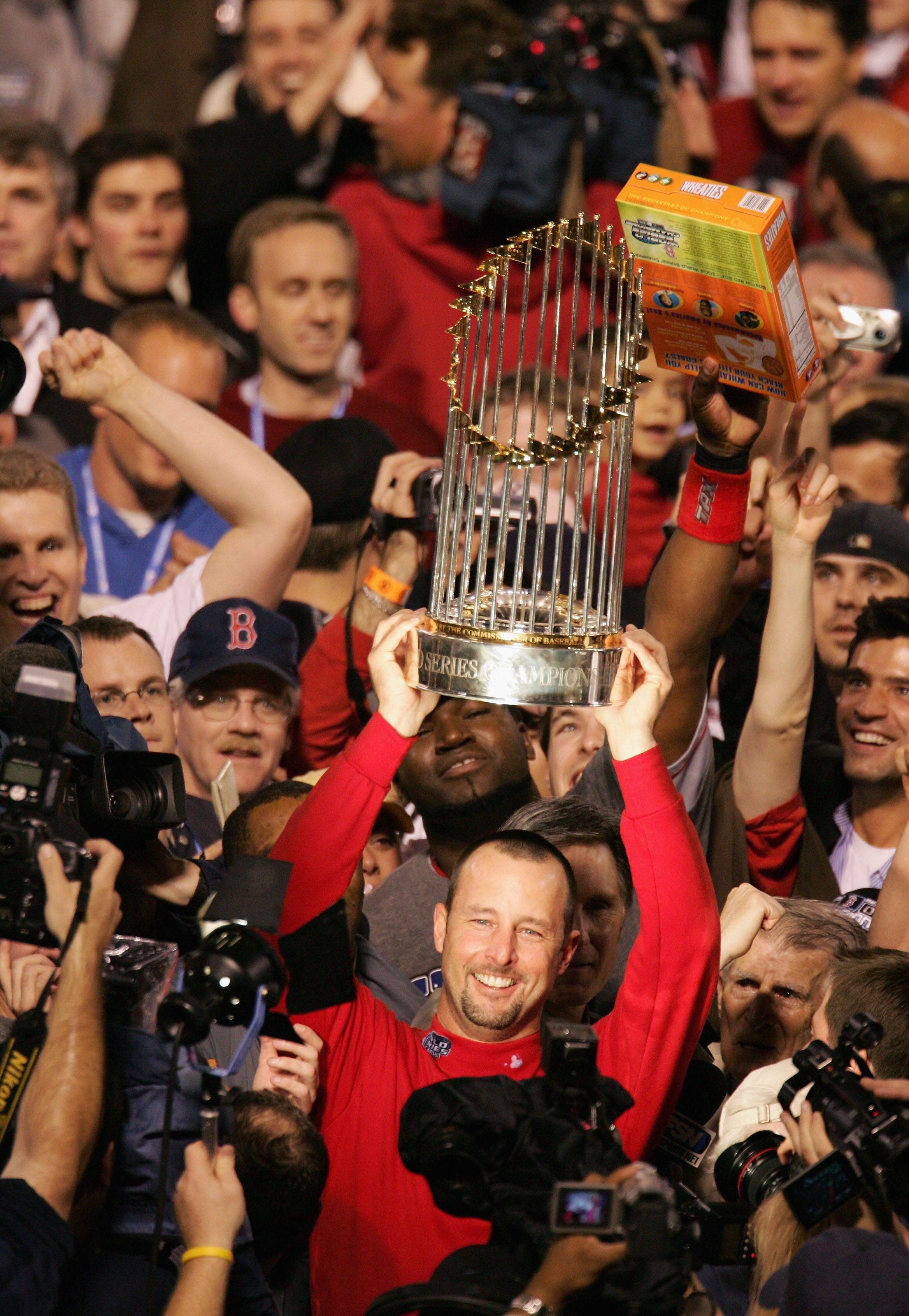 ST LOUIS - OCTOBER 27:  Tim Wakefield #49 of the Boston Red Sox celebrates with the trophy after defeating the St. Louis Cardinals 3-0 in game four of the World Series on October 27, 2004 at Busch Stadium in St. Louis, Missouri. (Photo by Al Bello/Getty I