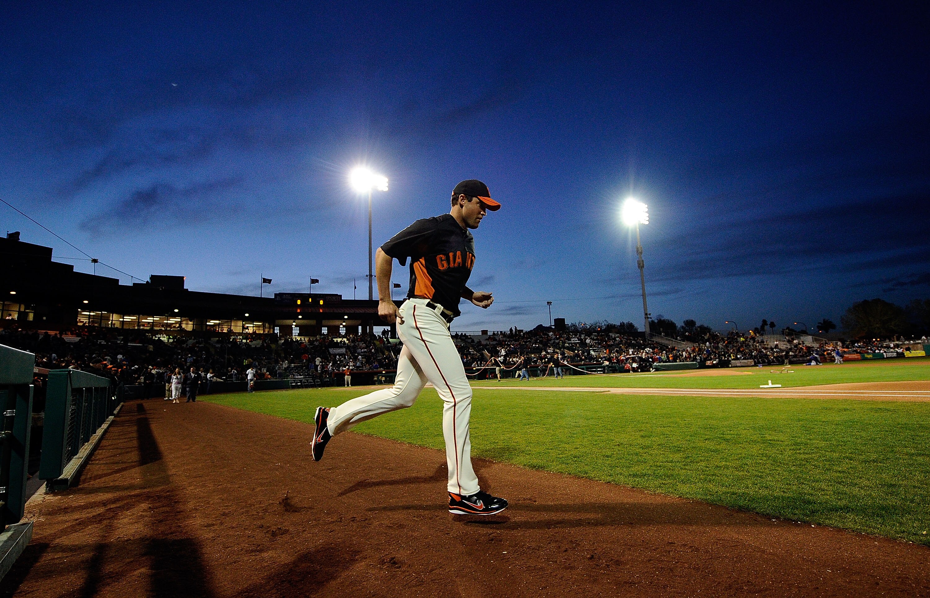 SCOTTSDALE, AZ - MARCH 07:  Cody Ross #13 of the San Francisco Giants runs out of the dugout for the start of the exhibition baseball game against the Texas Rangers in the first meeting between the two teams since the World Series during the spring traini