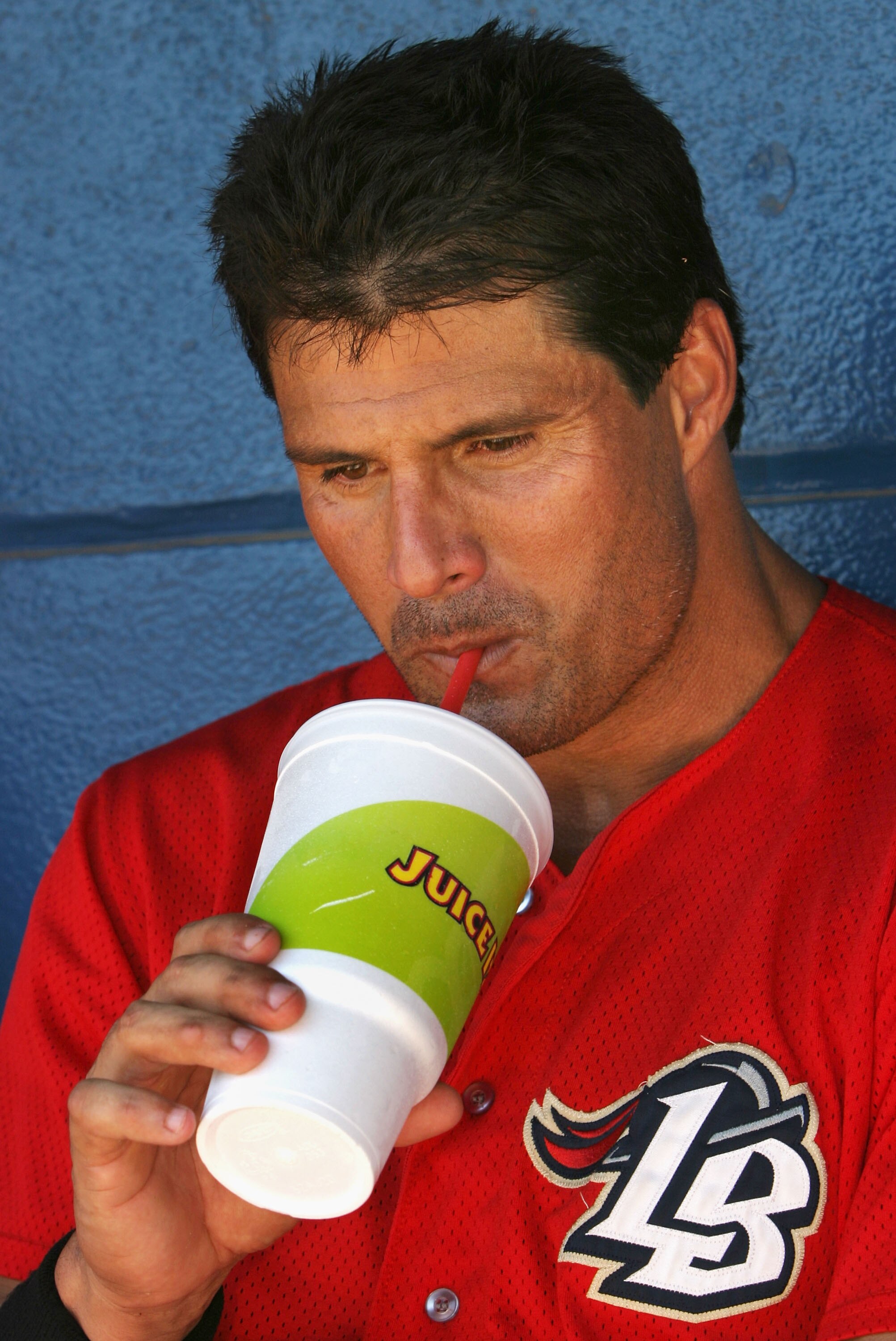 LONG BEACH, CA - JULY 16:  Jose Canseco #33 of the Long Beach Armada drinks a juice drink while resting in between Golden Baseball League games against the Fullerton Flyers on July 16, 2006 at Blair Field in Long Beach, California.  (Photo By Christian Pe