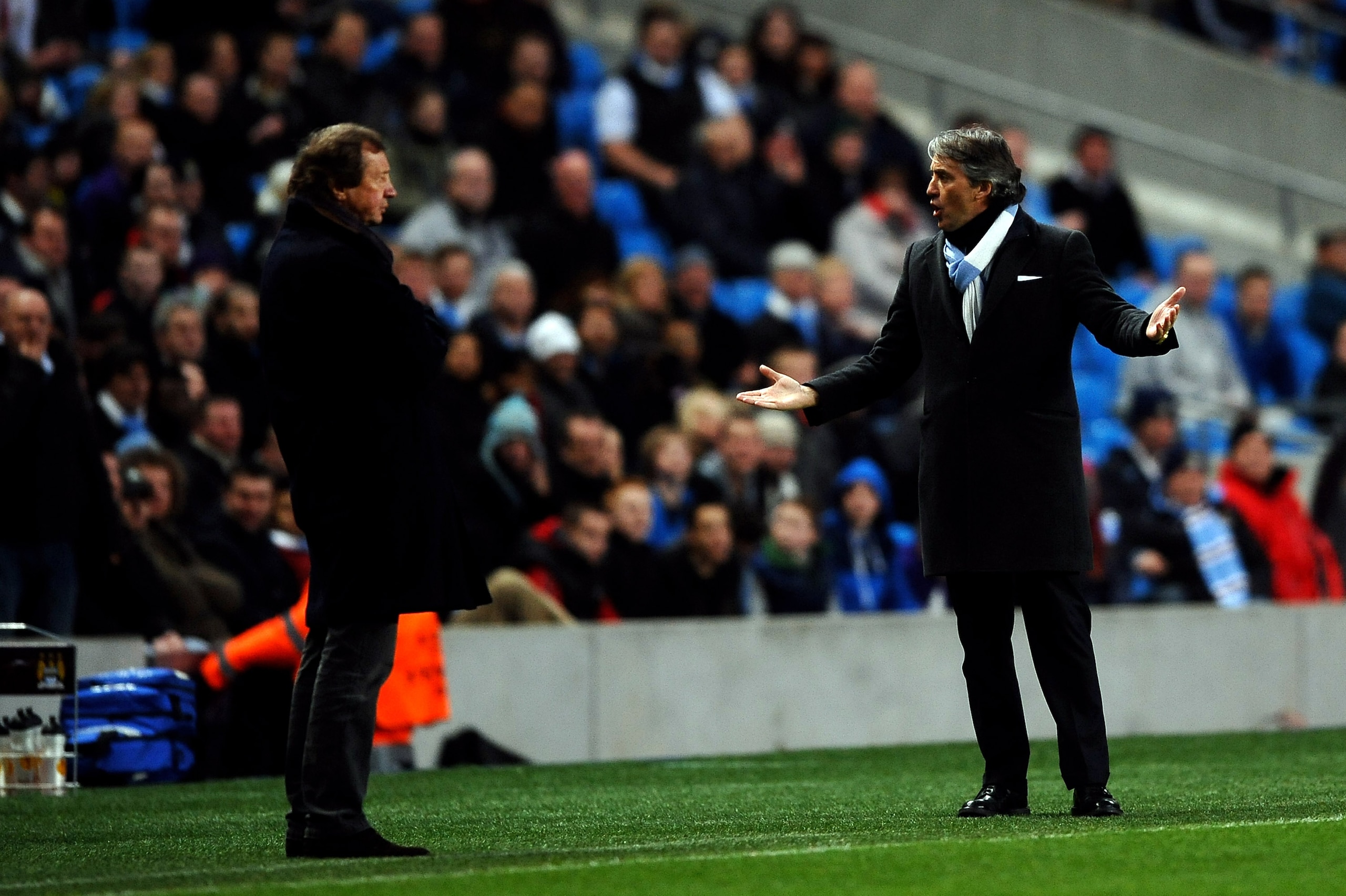 MANCHESTER, ENGLAND - MARCH 17:  Manager Roberto Mancini of Manchester City has words with Manager Yury Semin of Dynamo Kiev during the UEFA Europa League round of 16 second leg match between Manchester City and Dynamo Kiev at City of Manchester Stadium o