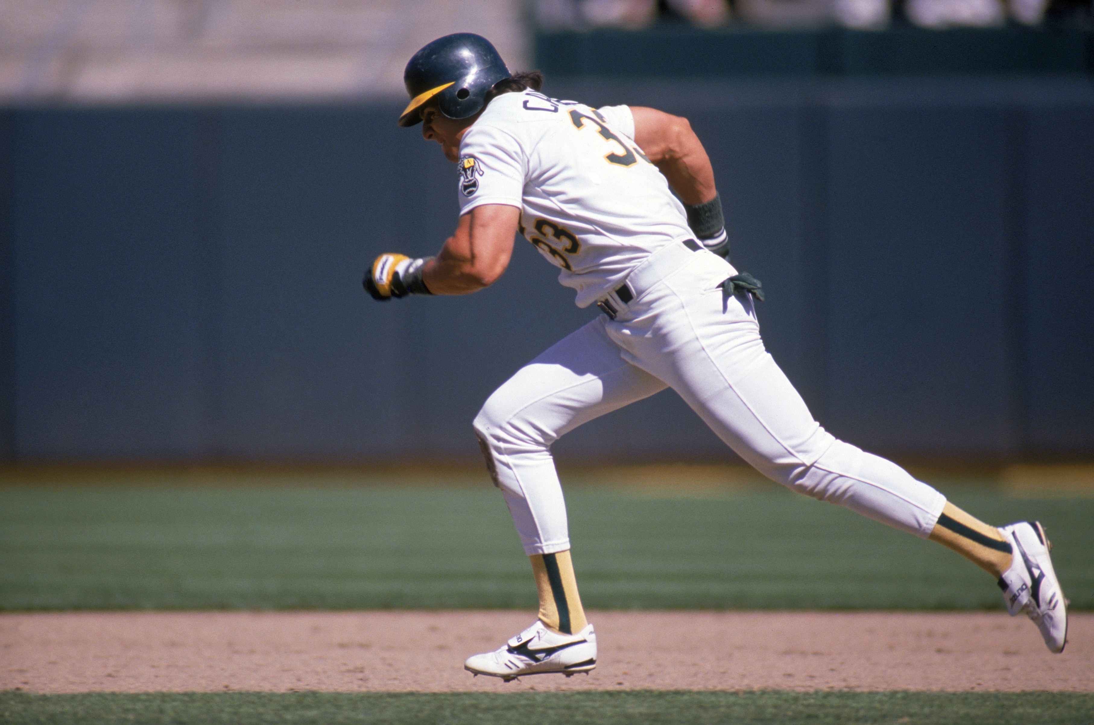 OAKLAND, CA -1988:  Jose Canseco #33 of the Oakland Athletics runs between the bases during a 1988 MLB season game at Oakland-Alameda County Coliseum in Oakland, California.  (Photo by Otto Greule Jr/Getty Images)