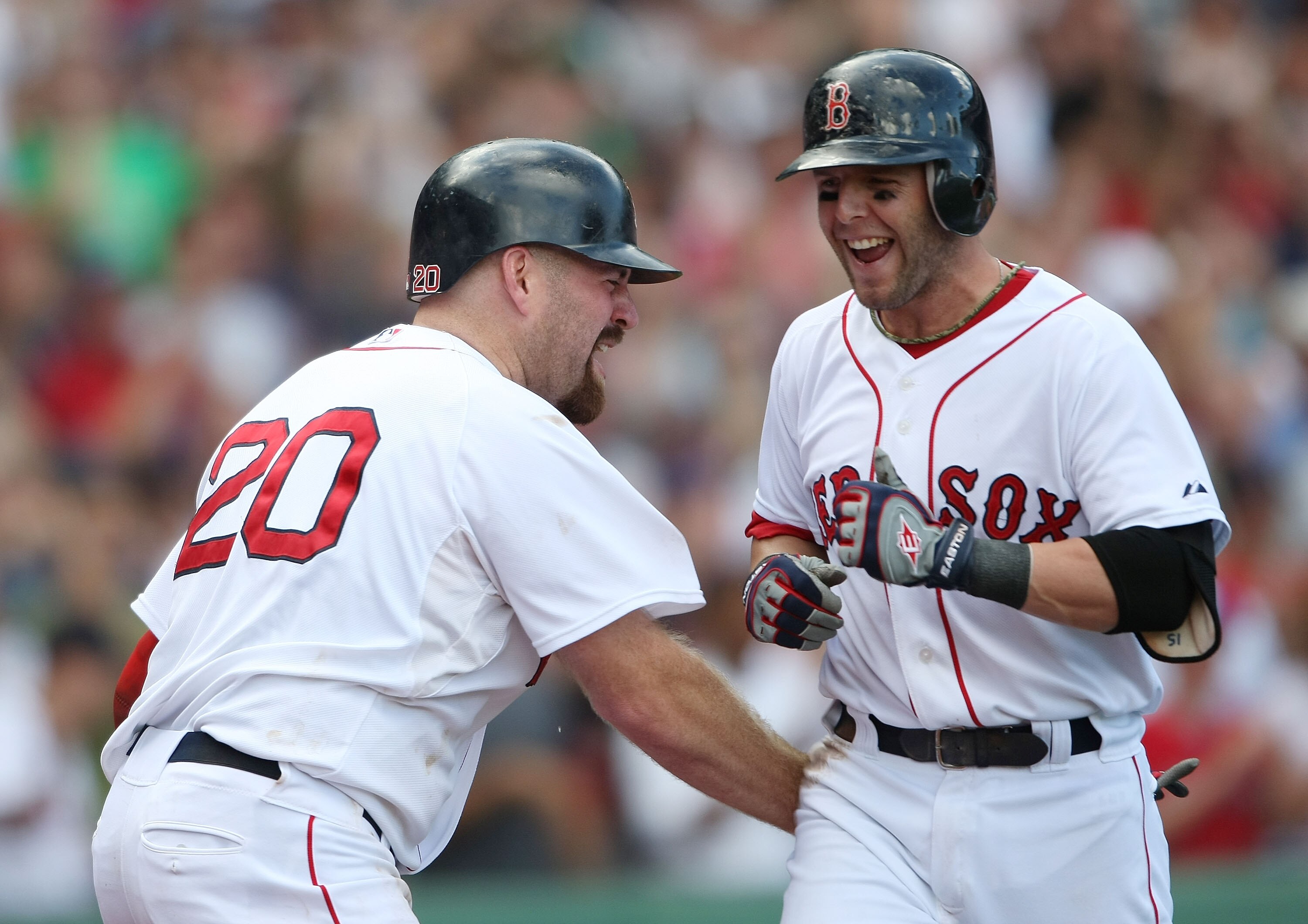 BOSTON - SEPTEMBER 13:  Dustin Pedroia #15 of the Boston Red Sox is congratulated by teammate Kevin Youkils #20 after Pedroia hit the game winning home run against the Tampa Bay Rays on September 13, 2009 at Fenway Park in Boston, Massachusetts. Pedroia d