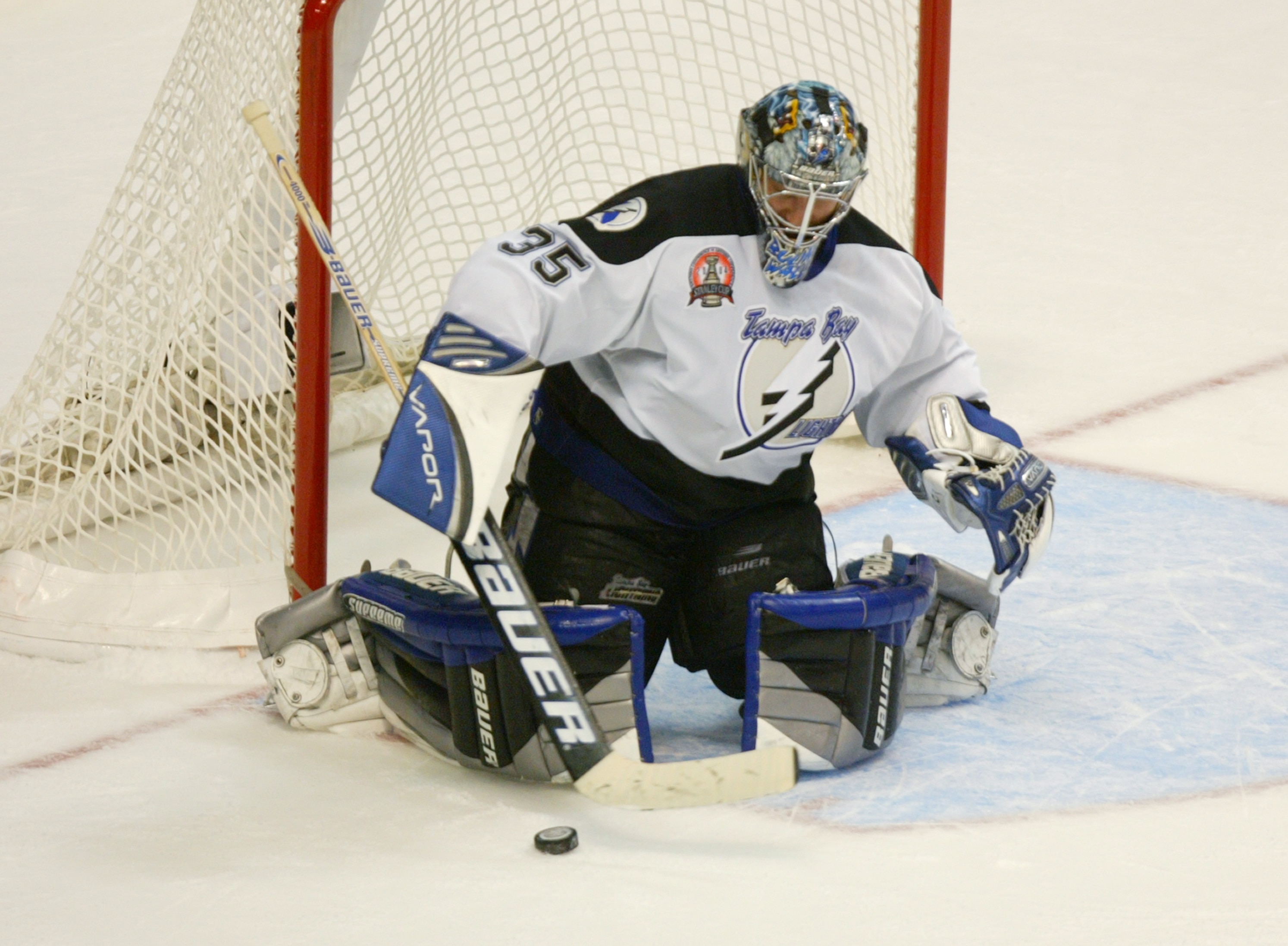 CALGARY, CANADA - JUNE 5:  Nikolai Khabibulin #35 of the Tampa Bay Lightning makes a save as he eyes the puck against the Calgary Flames in Game six of the NHL Stanley Cup Finals on June 5, 2004 at Pengrowth Saddledome in Calgary, Canada.  The Lightning d
