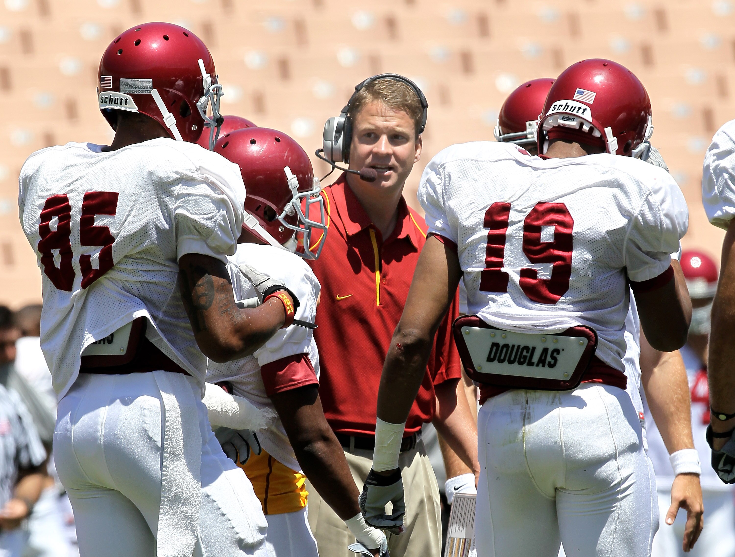 LOS ANGELES, CA - MAY 01:  Head coach Lane Kiffin gives instructions in the offensive huddle during the  USC Trojans spring game on  May 1, 2010 at the Los Angeles Memorial Coliseum in Los Angeles, California.  (Photo by Stephen Dunn/Getty Images)