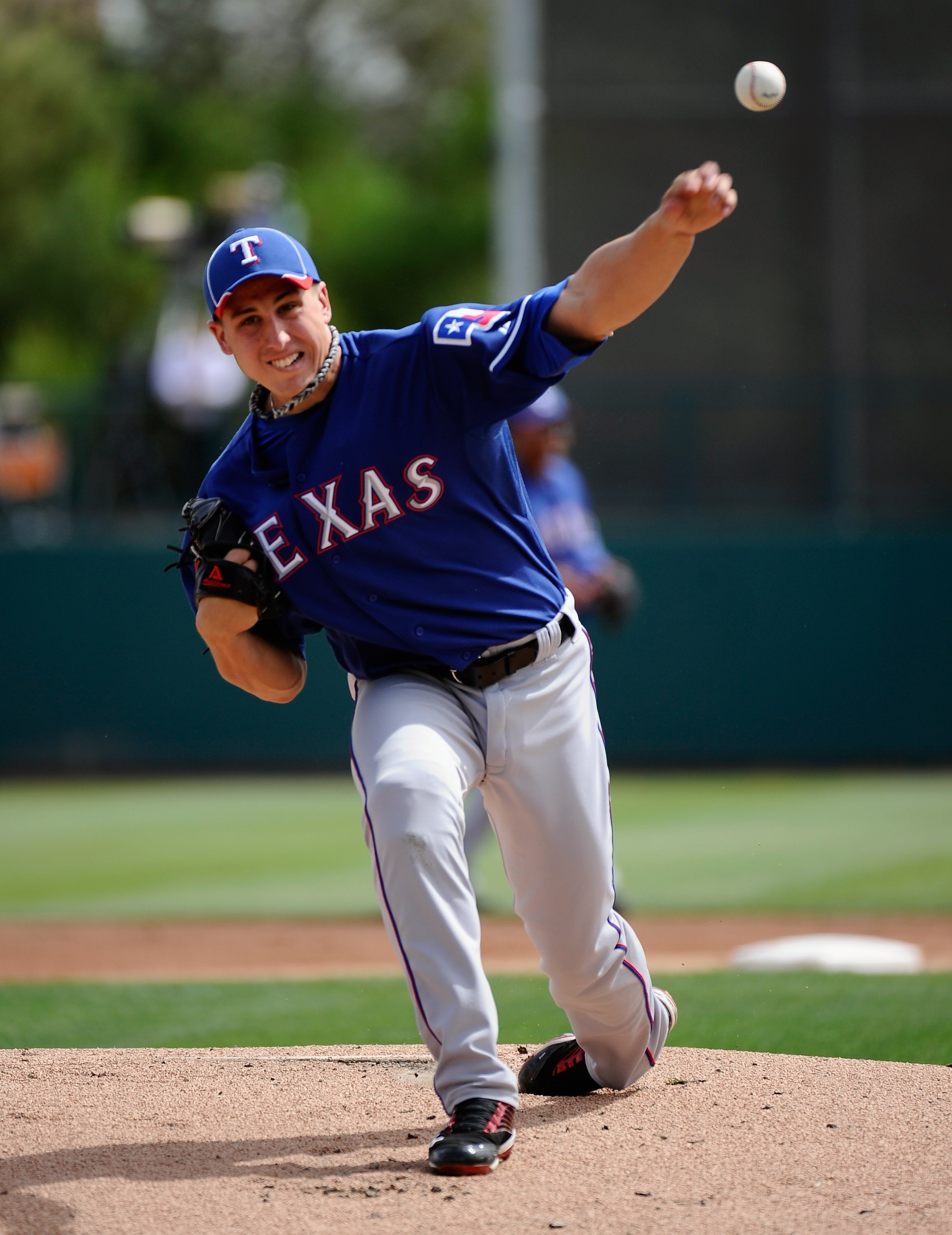 GLENDALE, AZ - MARCH 15:  Pitcher of Derek Holland #45 of the Texas Rangers  throws a pitch against the Los Angeles Dodgers during the spring training baseball game at Camelback Ranch on March 15, 2011 in Glendale, Arizona.  (Photo by Kevork Djansezian/Ge
