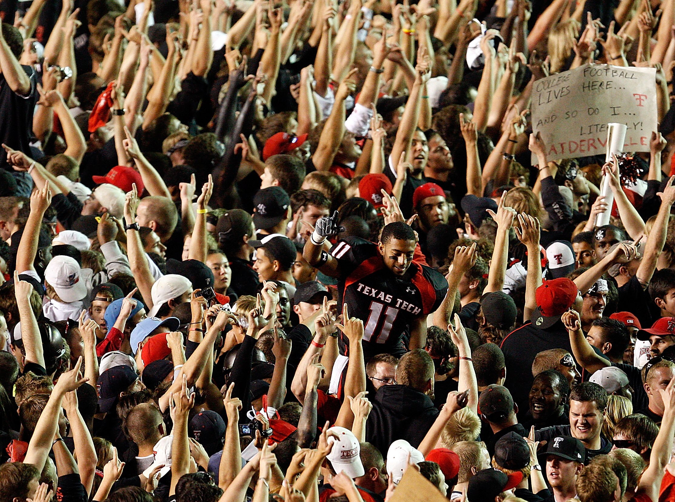 LUBBOCK, TX - NOVEMBER 01:  Fans swarm the field and lift Tramain Swindall #11 after the Texas Tech Red Raiders defeated the Texas Longhorns with a final score of 34-33 on November 1, 2008 at Jones Stadium in Lubbock, Texas.  (Photo by Jamie Squire/Getty