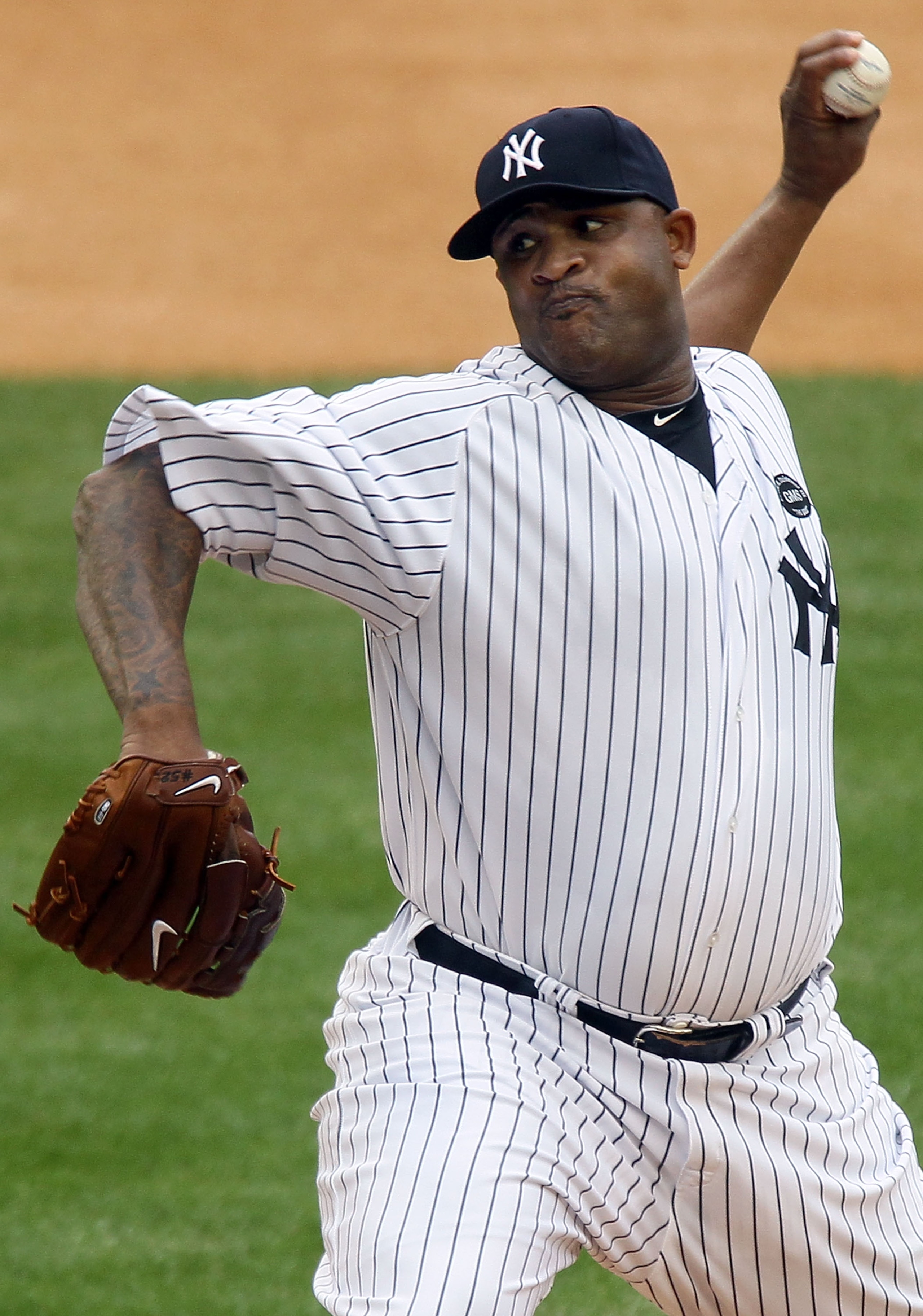 NEW YORK - AUGUST 22:  CC Sabathia #52 of the New York Yankees delivers a pitch against the Seattle Mariners on August 22, 2010 at Yankee Stadium in the Bronx borough of New York City.  (Photo by Jim McIsaac/Getty Images)