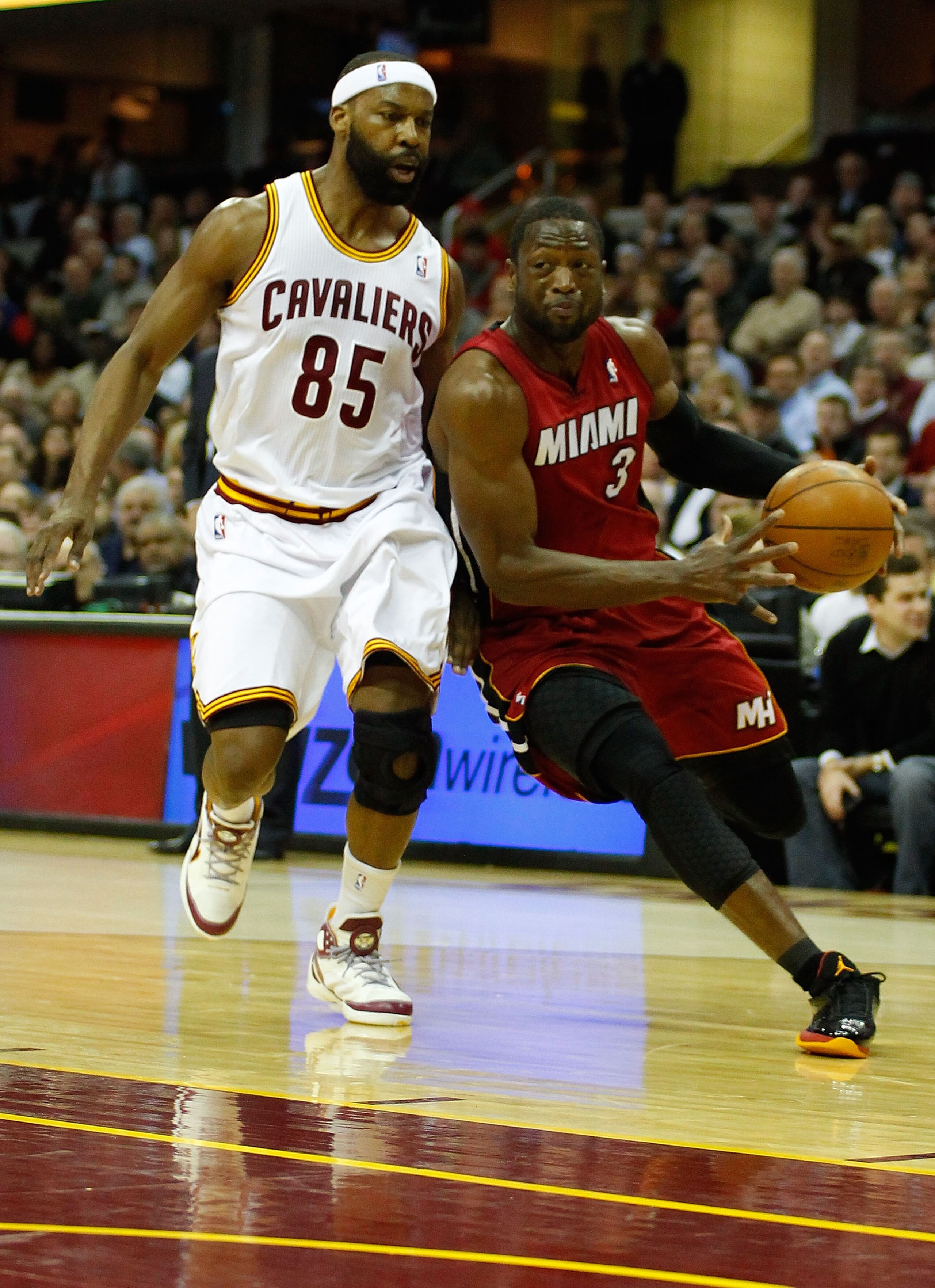 CLEVELAND - MARCH 29: Dwyane Wade #3 of the Miami Heat drives to the basket against Baron Davis #85 of the Cleveland Cavaliers during the game on March 29, 2011 at Quicken Loans Arena in Cleveland, Ohio. NOTE TO USER: User expressly acknowledges and agree