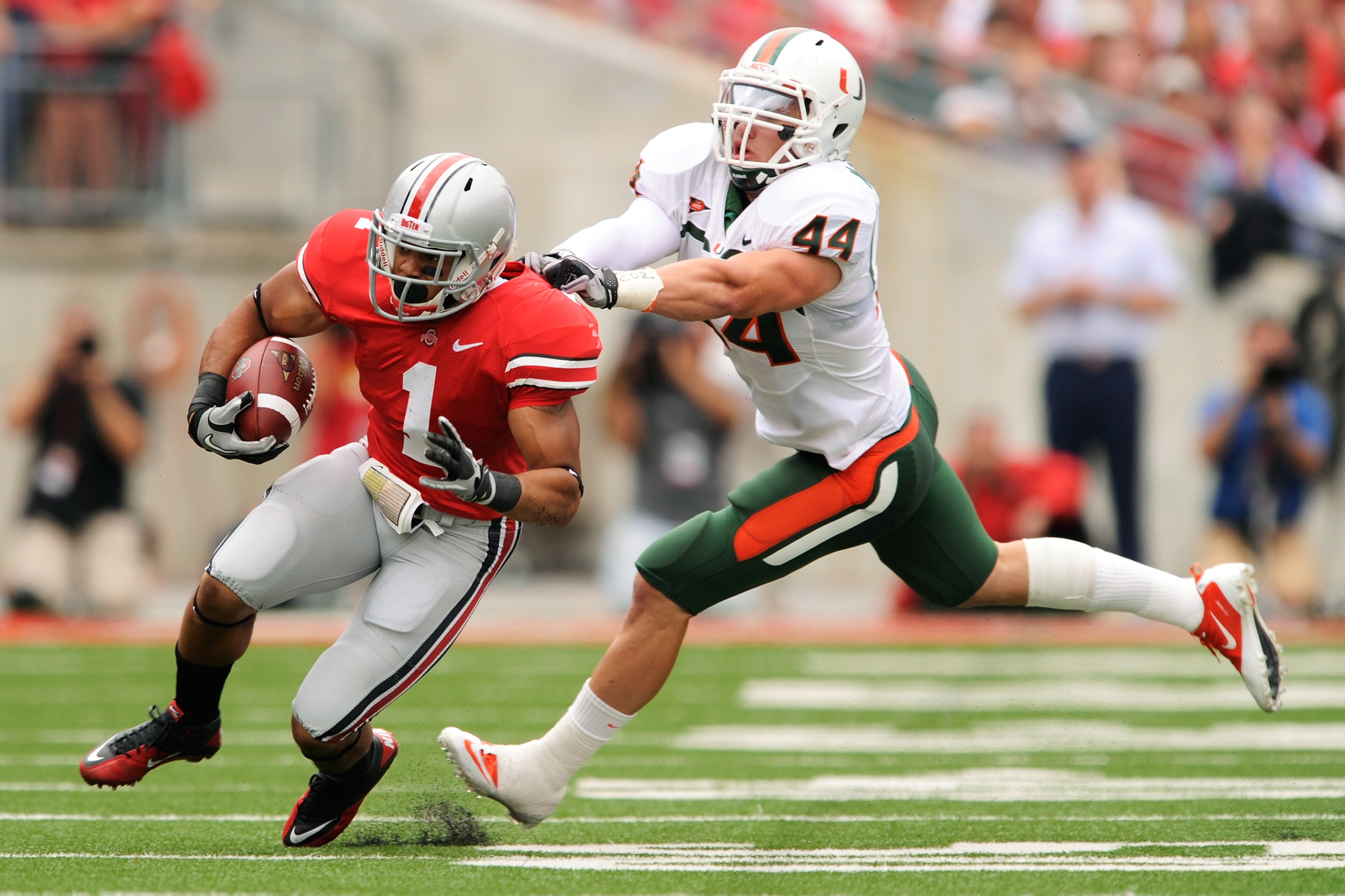 COLUMBUS, OH - SEPTEMBER 11:  Colin McCarthy #44 of the Miami Hurricanes attempts to tackle Dan Herron #1 of the Ohio State Buckeyes at Ohio Stadium on September 11, 2010 in Columbus, Ohio.  (Photo by Jamie Sabau/Getty Images)
