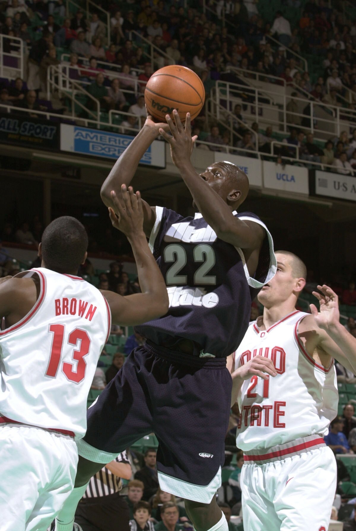 15 Mar 2001:  Curtis Bobb #22 of Utah State takes a shot while guarded by Brian Brown #13 and Boban Savovic #21 of Ohio State in the first round of the Men's NCAA Tournament at Greensboro Coliseum in Greensboro, North Carolina.  DIGITAL IMAGE Mandatory Cr