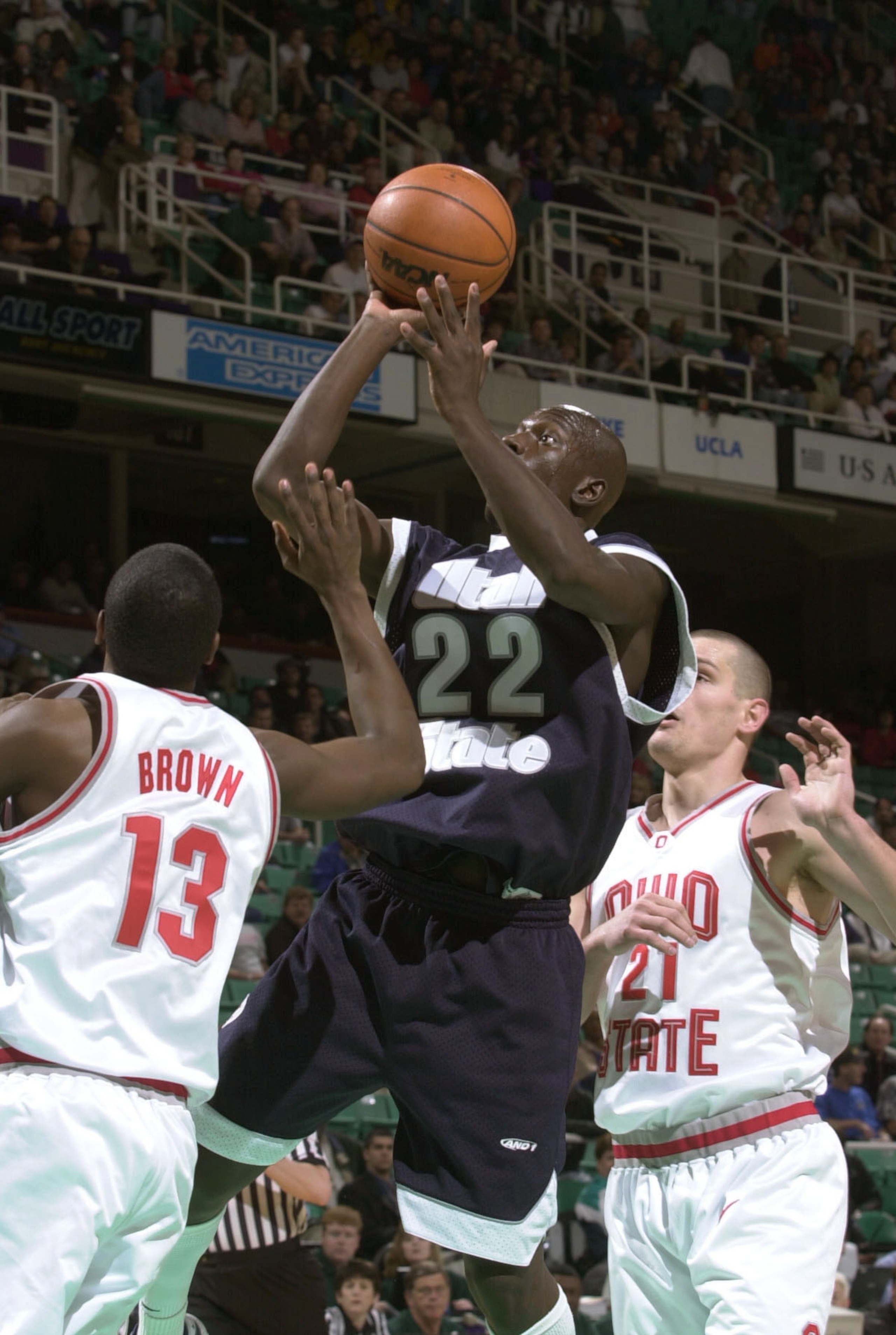 15 Mar 2001:  Curtis Bobb #22 of Utah State takes a shot while guarded by Brian Brown #13 and Boban Savovic #21 of Ohio State in the first round of the Men's NCAA Tournament at Greensboro Coliseum in Greensboro, North Carolina.  DIGITAL IMAGE Mandatory Cr