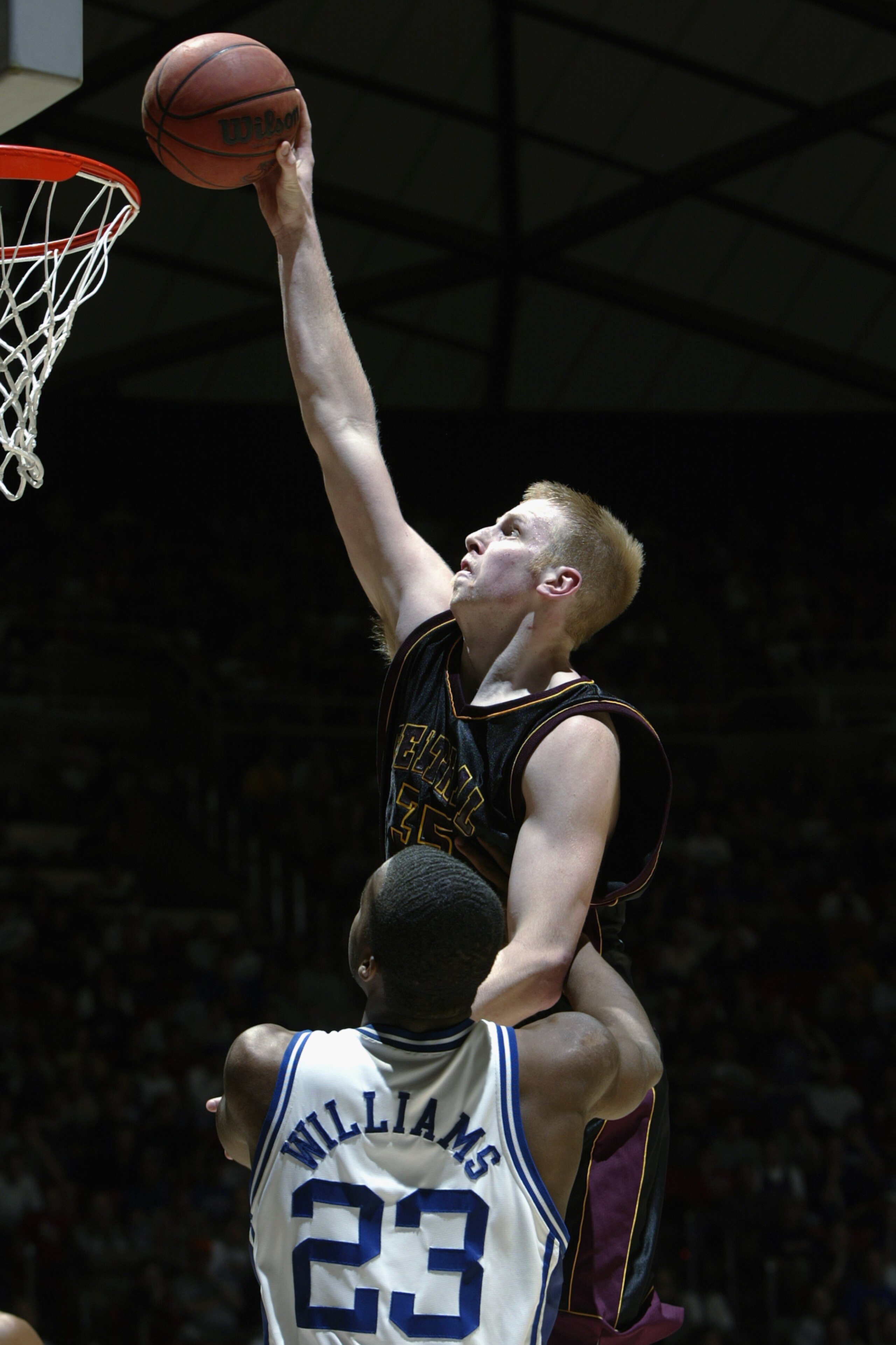SALT LAKE CITY - MARCH 22:  Chris Kaman #35 of Central Michigan makes a dunk over Shelden Williams #23 of Duke during the NCAA Tournament on March 22, 2003 at the Huntsman Center in Salt Lake City, Utah.  Duke defeated Central Michigan 86-60.  (Photo by J